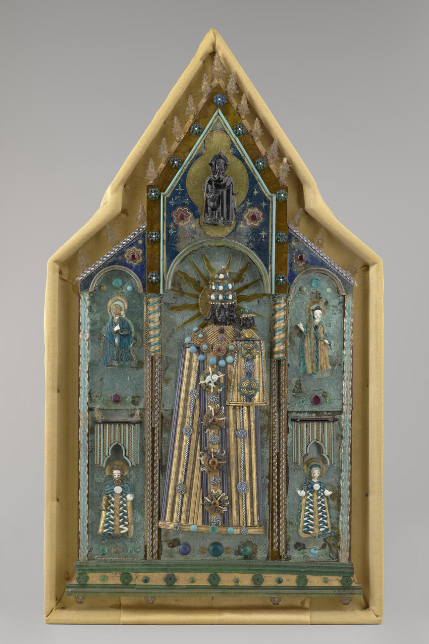 The Black Glass Madonna sculpture on the left before cleaning and conservation treatment looking dirty and dull and after treatment looking clear and sparkly