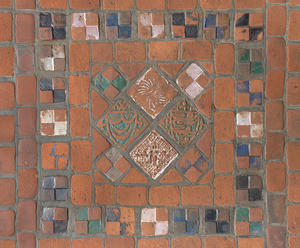 Two photographs of the brick red floor tiles in the Gothic Room before and after a cleaning.