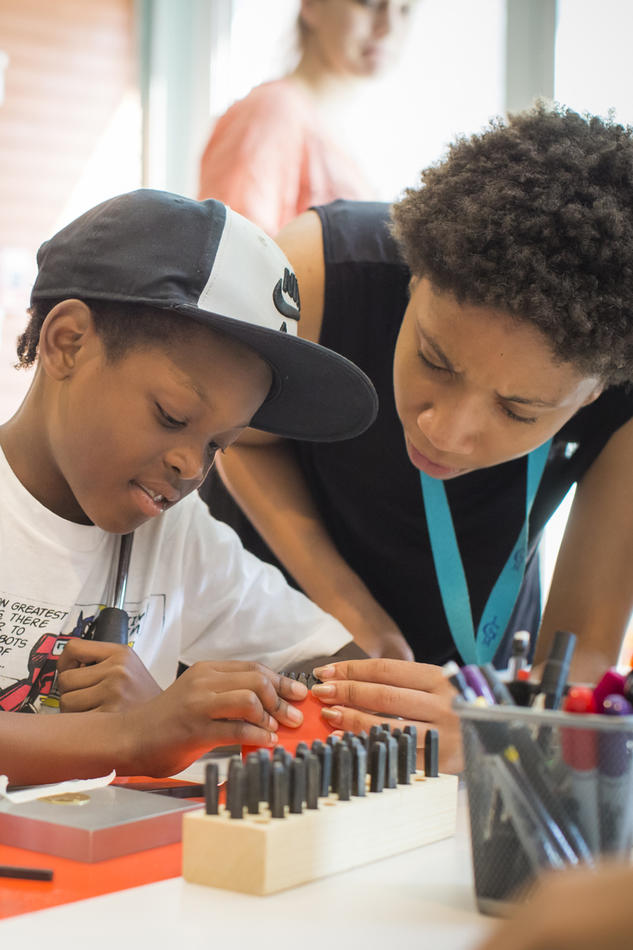 Visitors engage in art-making activities in the Studio.
