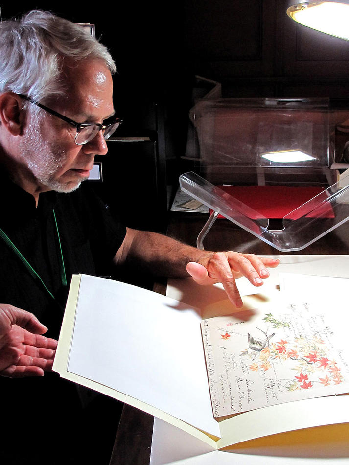 David Wilson looking at one of Isabella Stewart Gardner’s music programs from a performance at her house, Green Hill, 2010.
