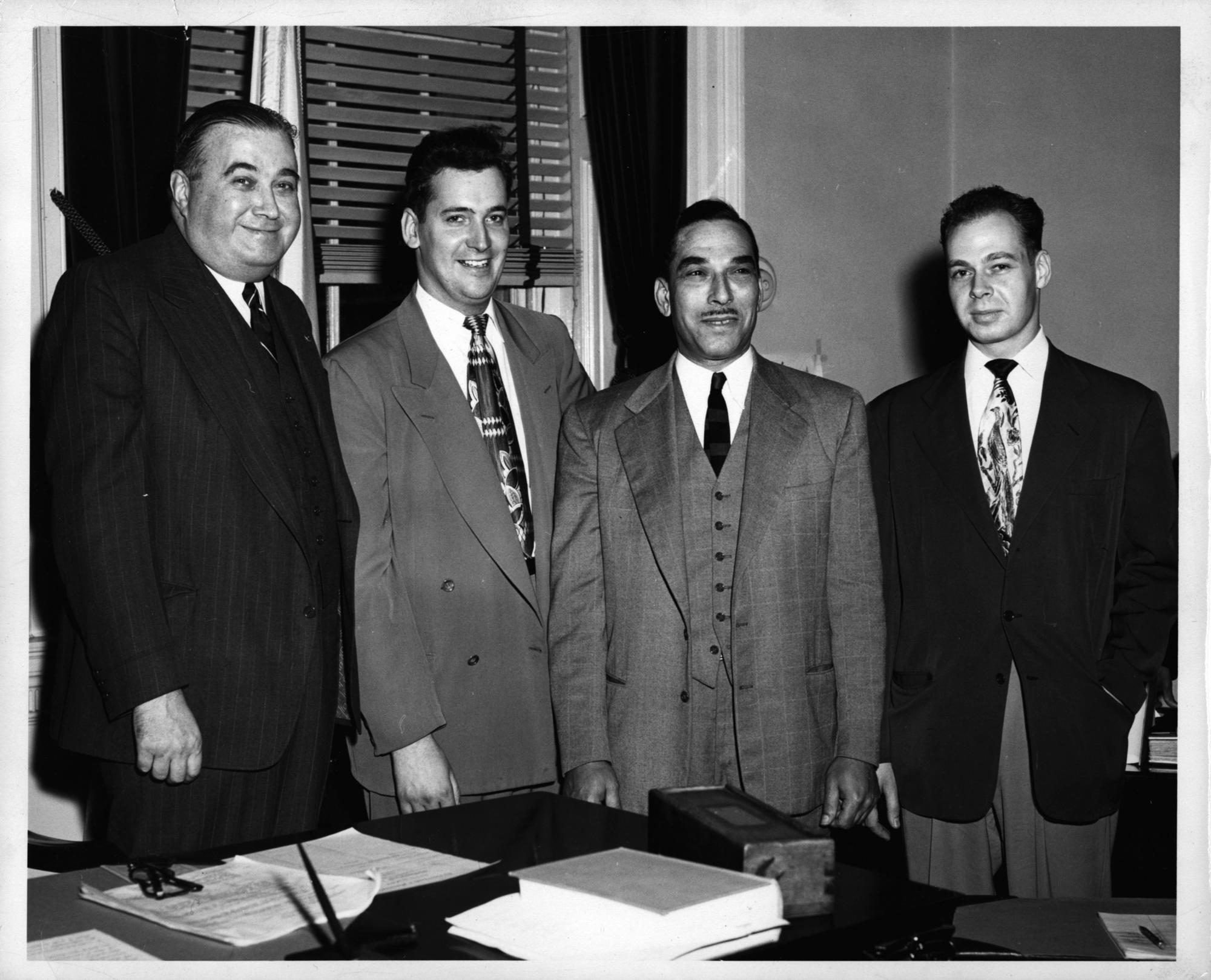 Governor Paul Dever, Representative Thomas H. [illegible], Judge Edward O. Gourdin, and Representative Vincent F. Cronin, identified as showing, left to right, undated. Photo courtesy of the Edward Gourdin Collection, Howard Gotlieb Archival Research Center, Boston University.