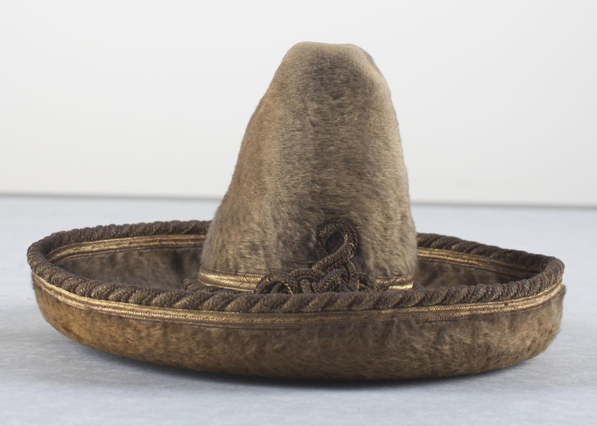 A small sombrero once perched on the desk below the painting of Saint Engracia by Bartolomé Bermejo in the Tapestry Room. 