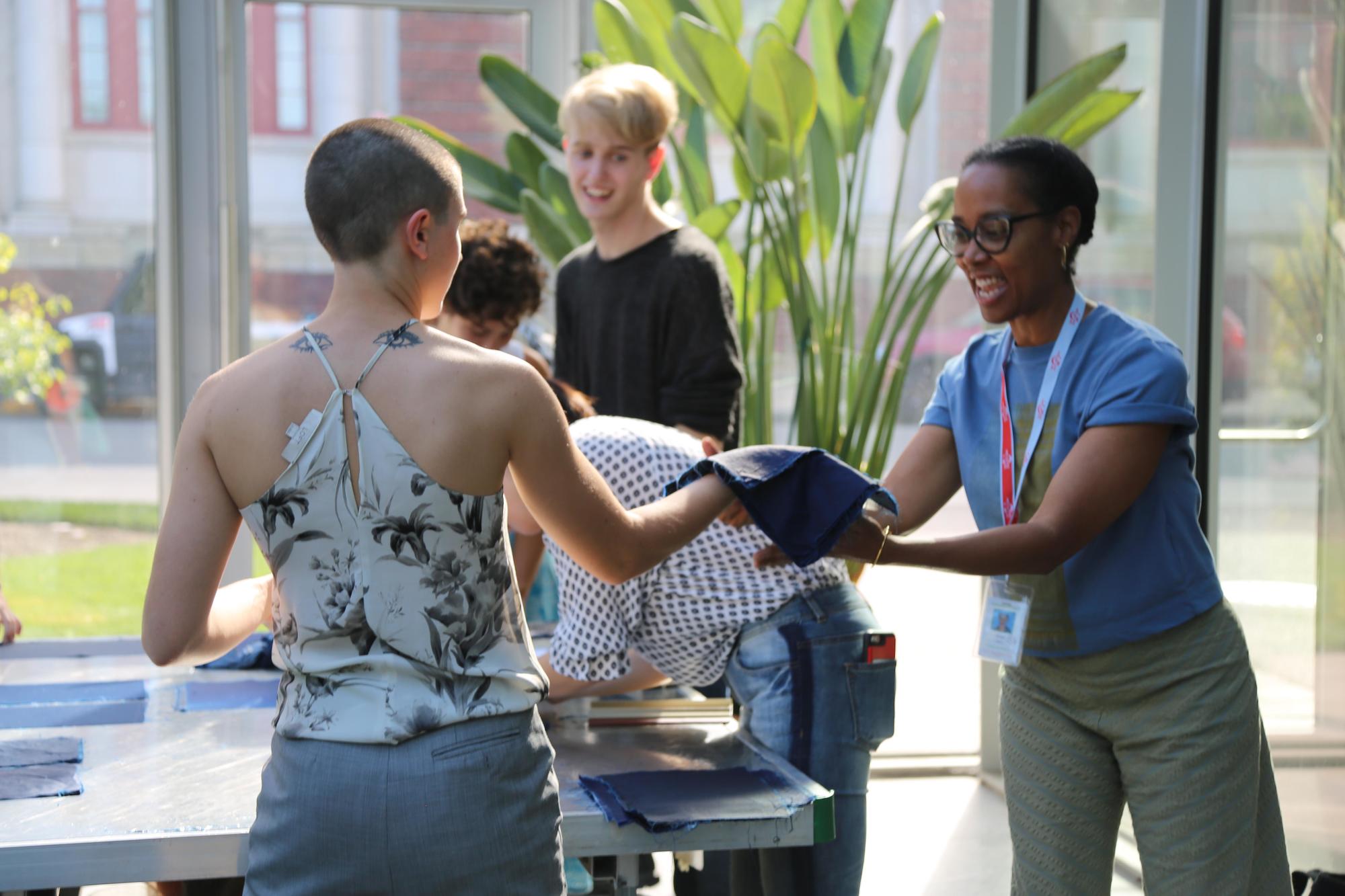 Sonya Clark and students from MassArt working on her cyanotype project in the Education Greenhouse, 2019