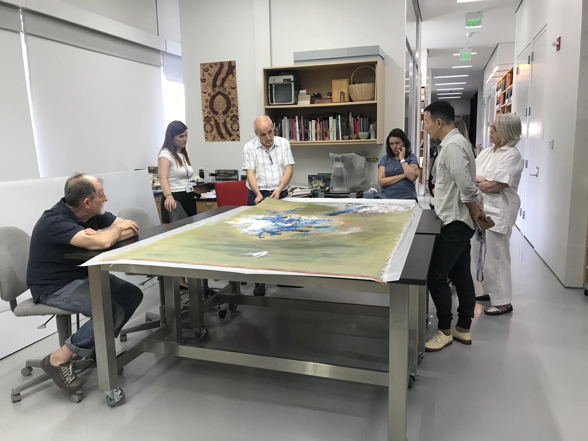 Shen Wei in the conservation lab preparing a work to be stretched for his upcoming exhibition, 2018