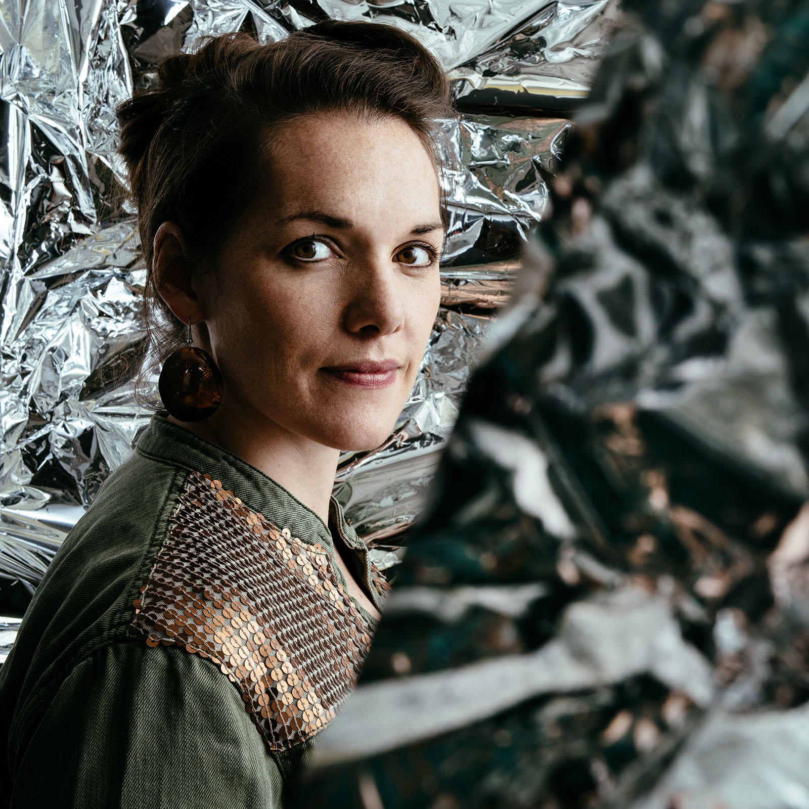 Maria Finkelmeier headshot amid crinkled reflective background