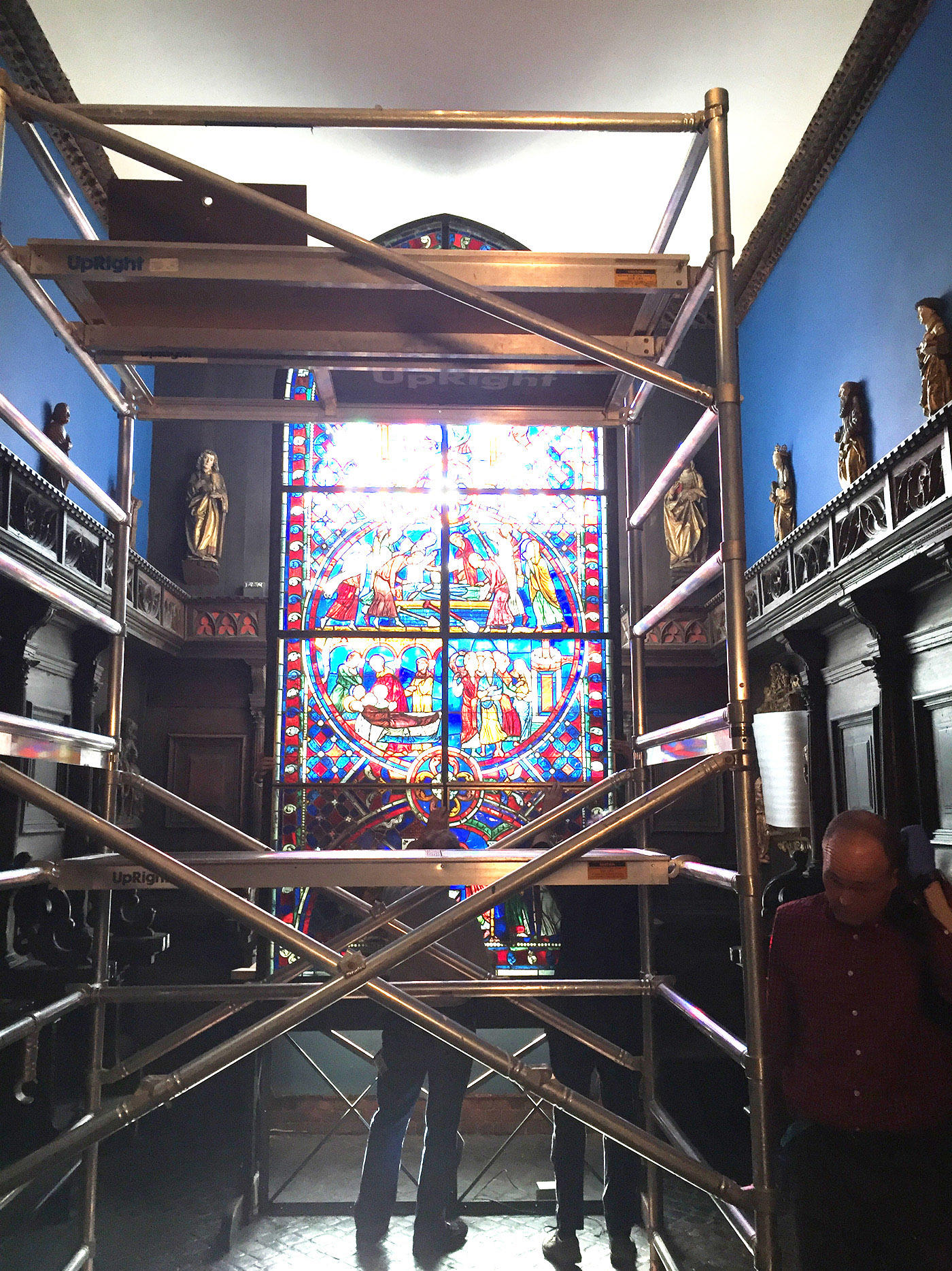 Museum staff prepare the scaffolding needed to remove the individual stained glass panels from the Soisson window, 2015