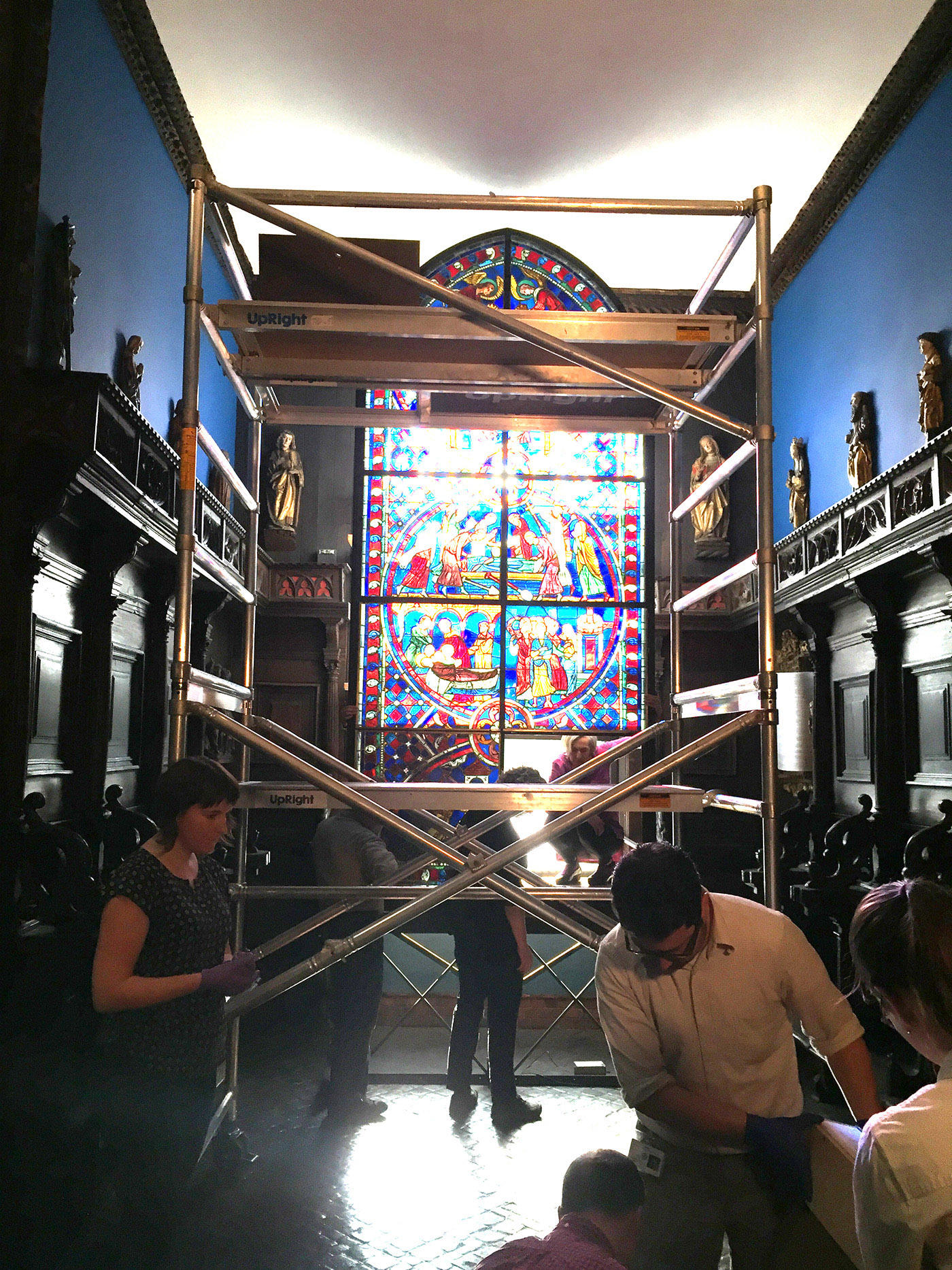  Museum staff remove the first stained glass panel from the lower portion of the Soisson window, 2015