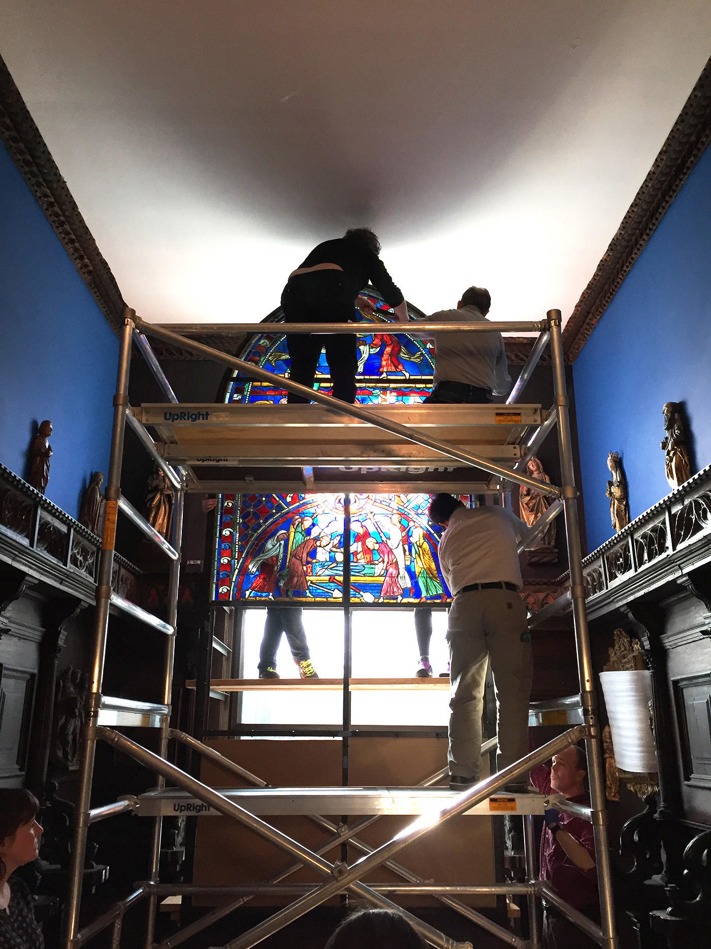 Museum staff remove stained glass panels from the top portion of the Soisson window, 2015