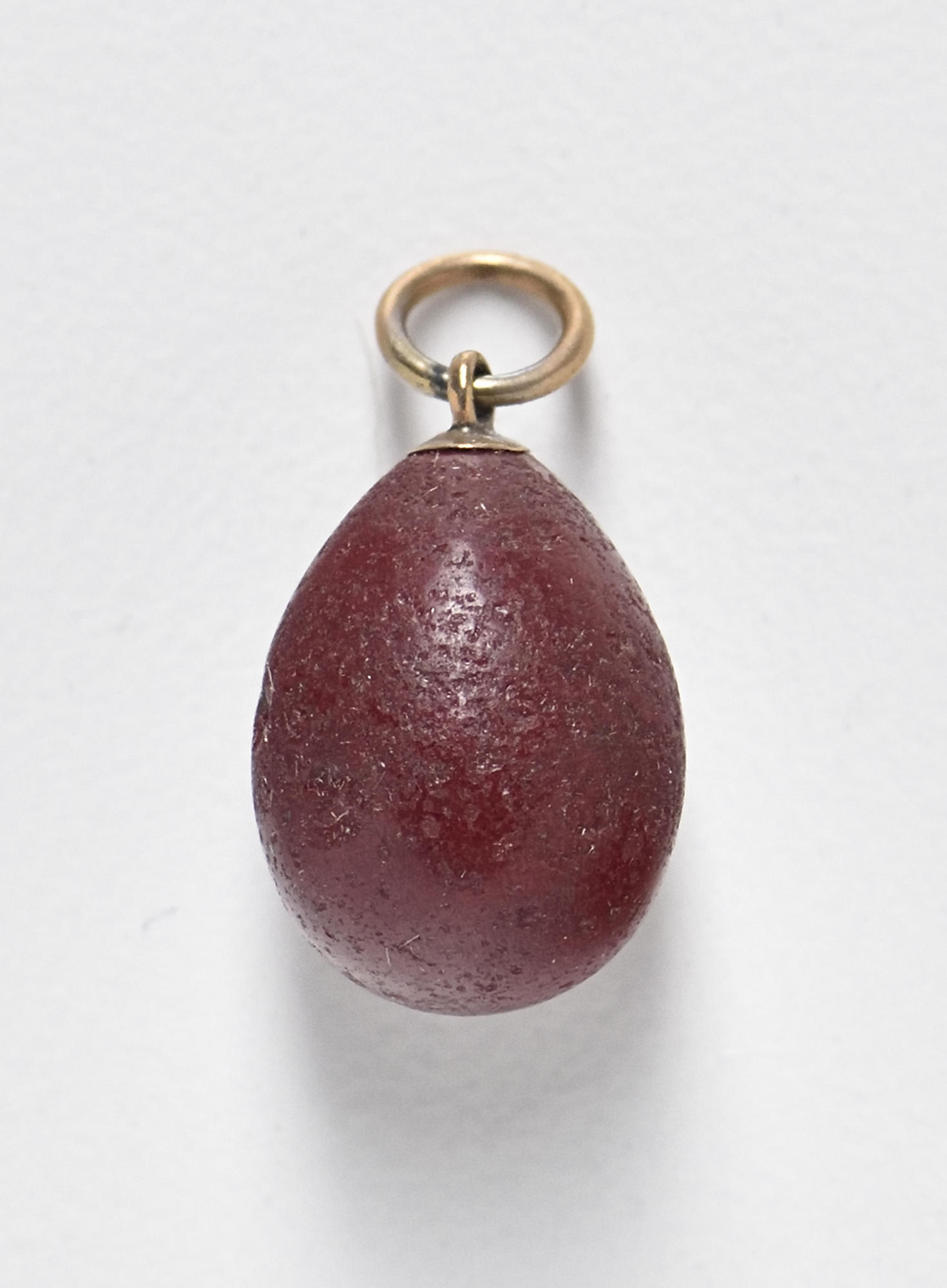 A red egg shaped pendant