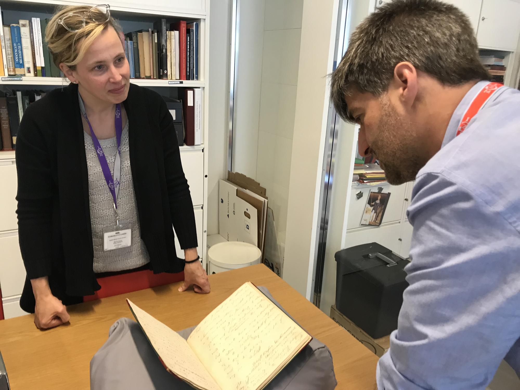 James Prosek looking at a book