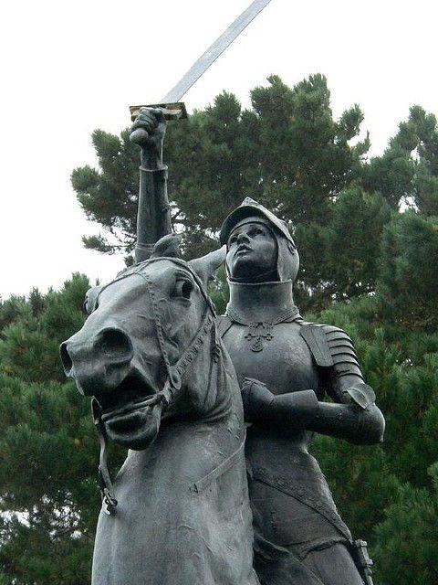 A close up of a black statue of Joan of Arc