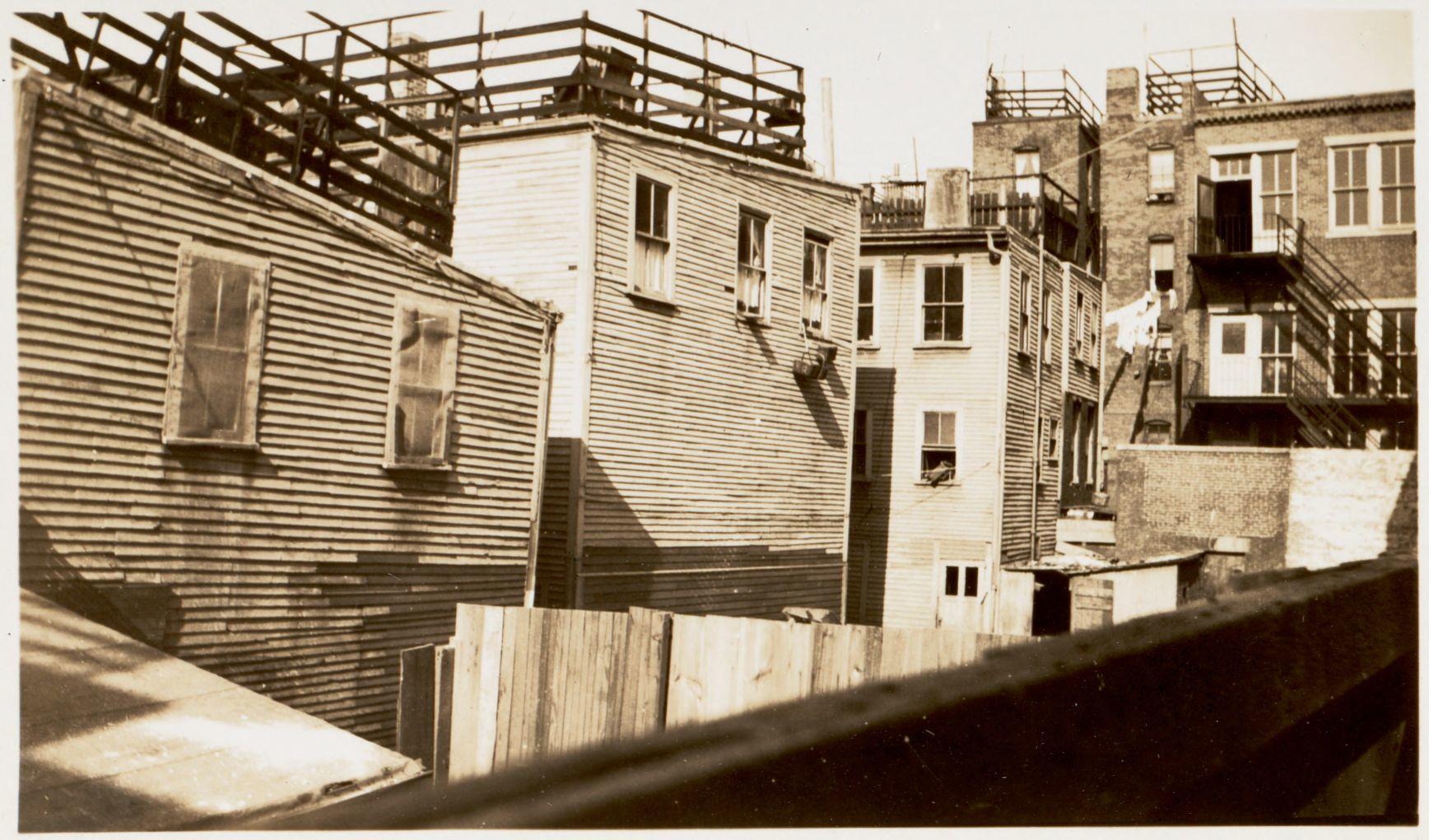 A sepia photo of close together apartments.
