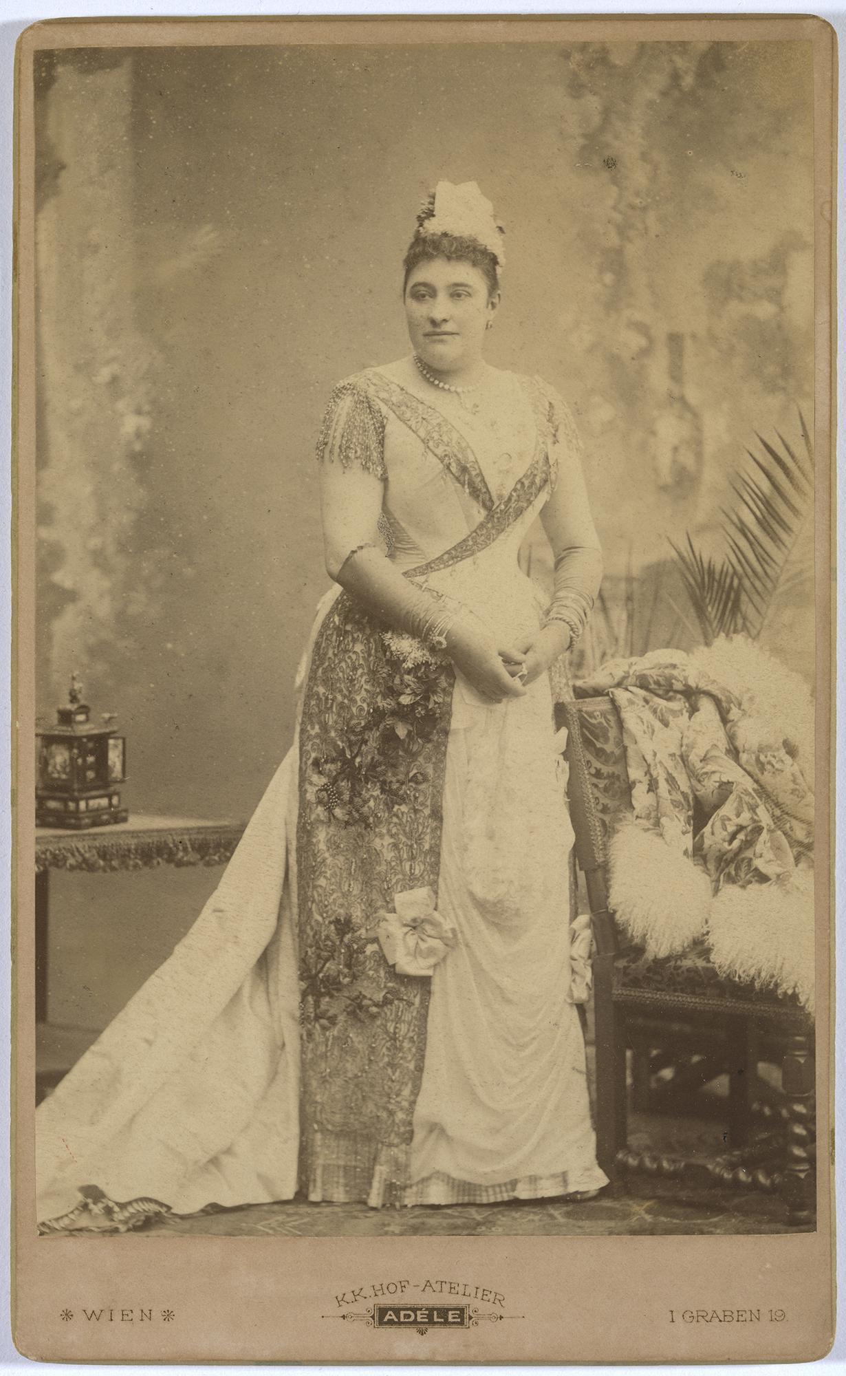 A regal woman in a dress posing for a photo.