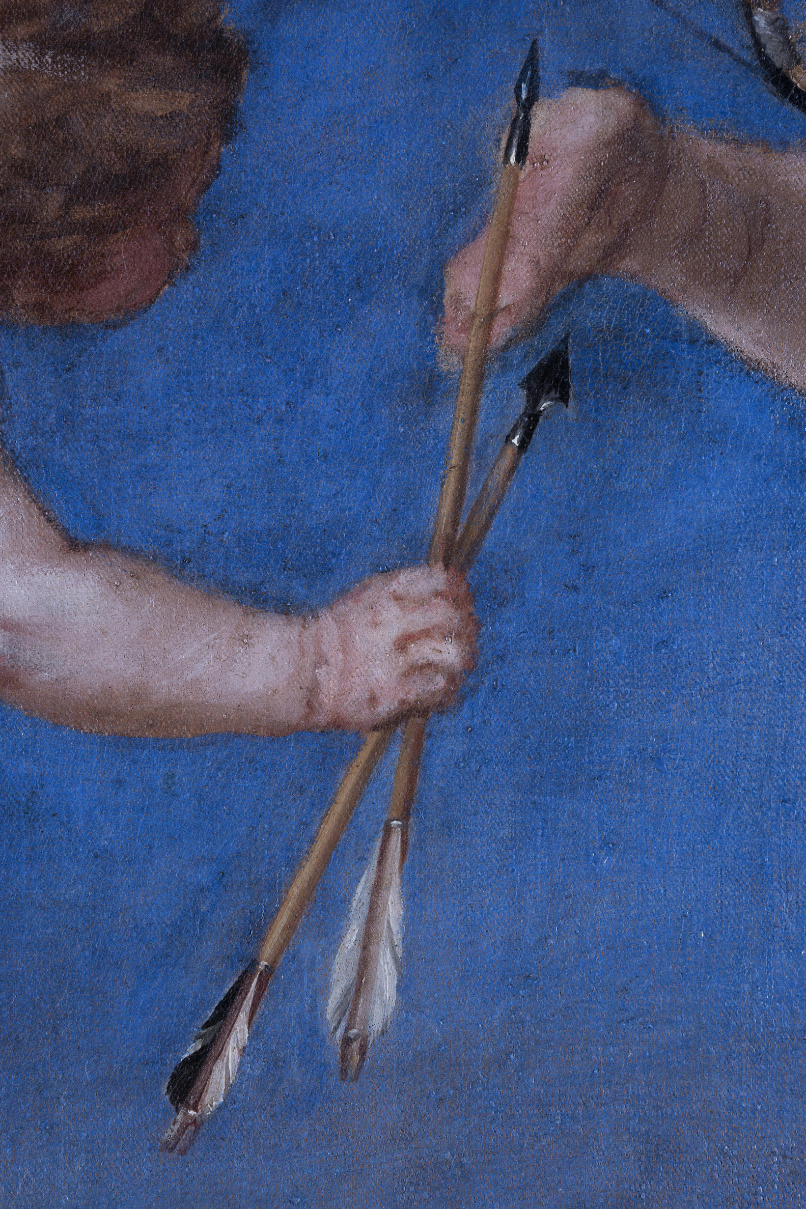 A close up of a hand holding an arrow. 