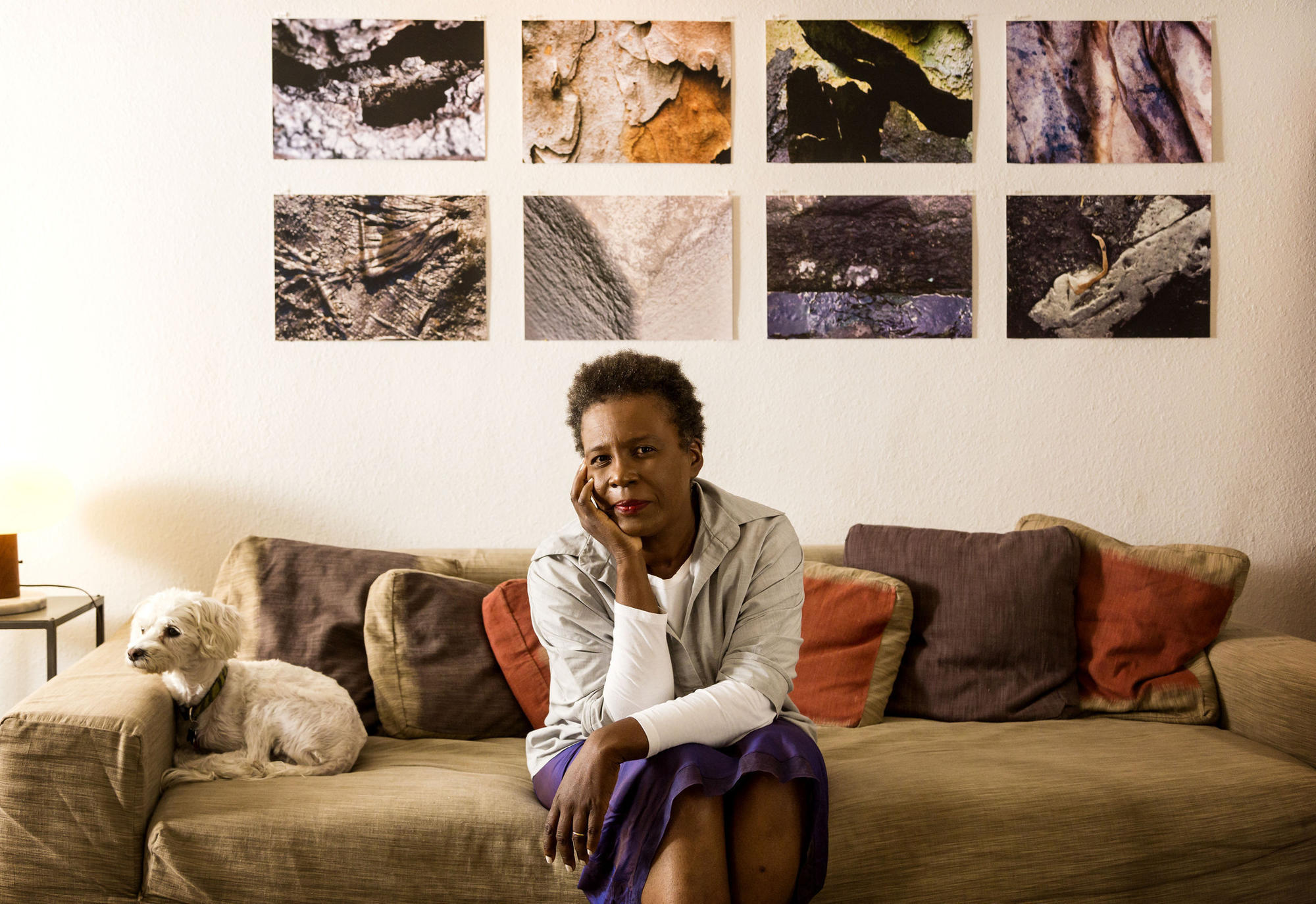 Claudia Rankine sitting on a couch.