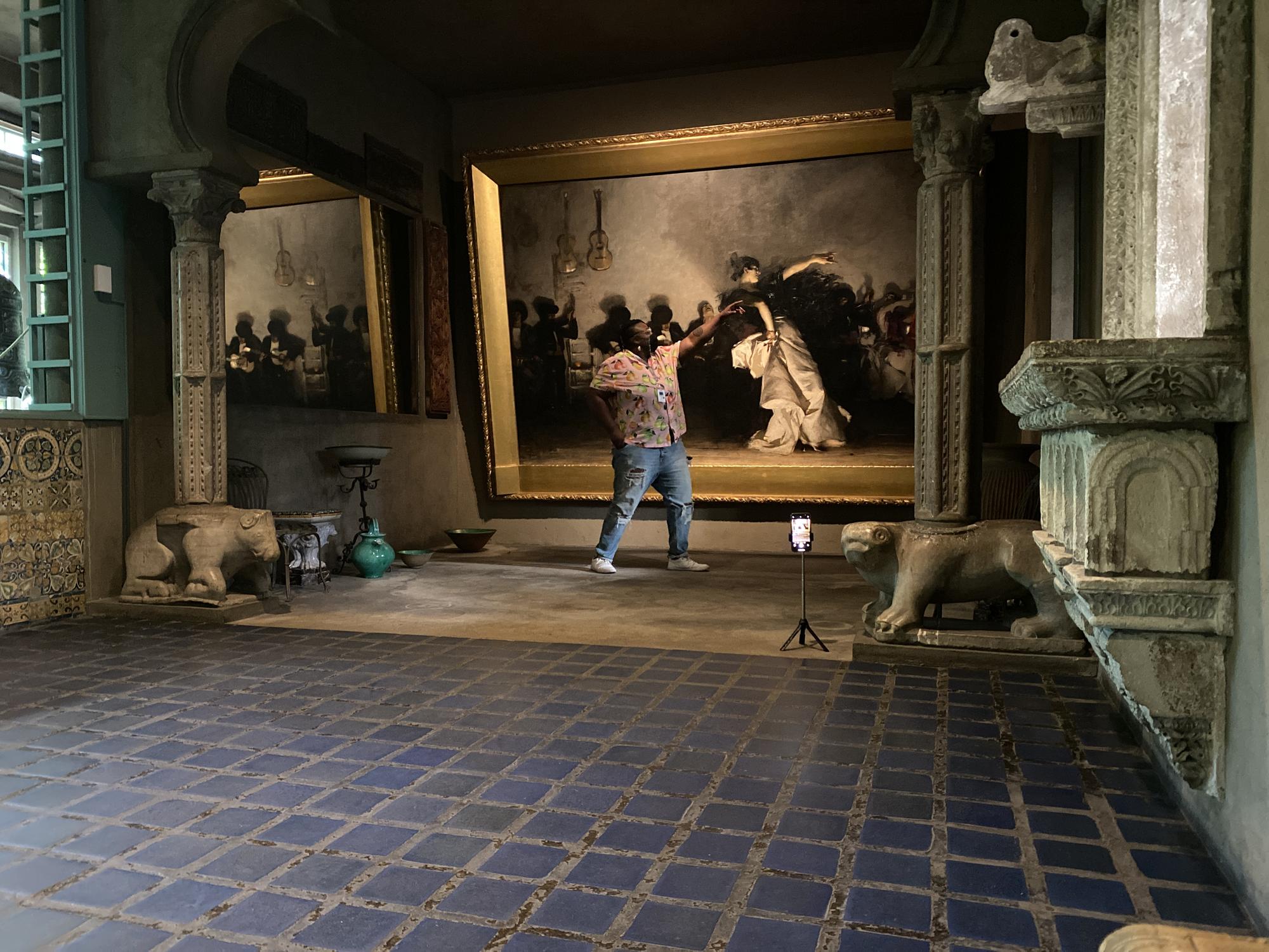 Porsha Olayiwola takes a selfie in front of a painting in the Spanish Cloister at the Isabella Stuart Gardner Museum.