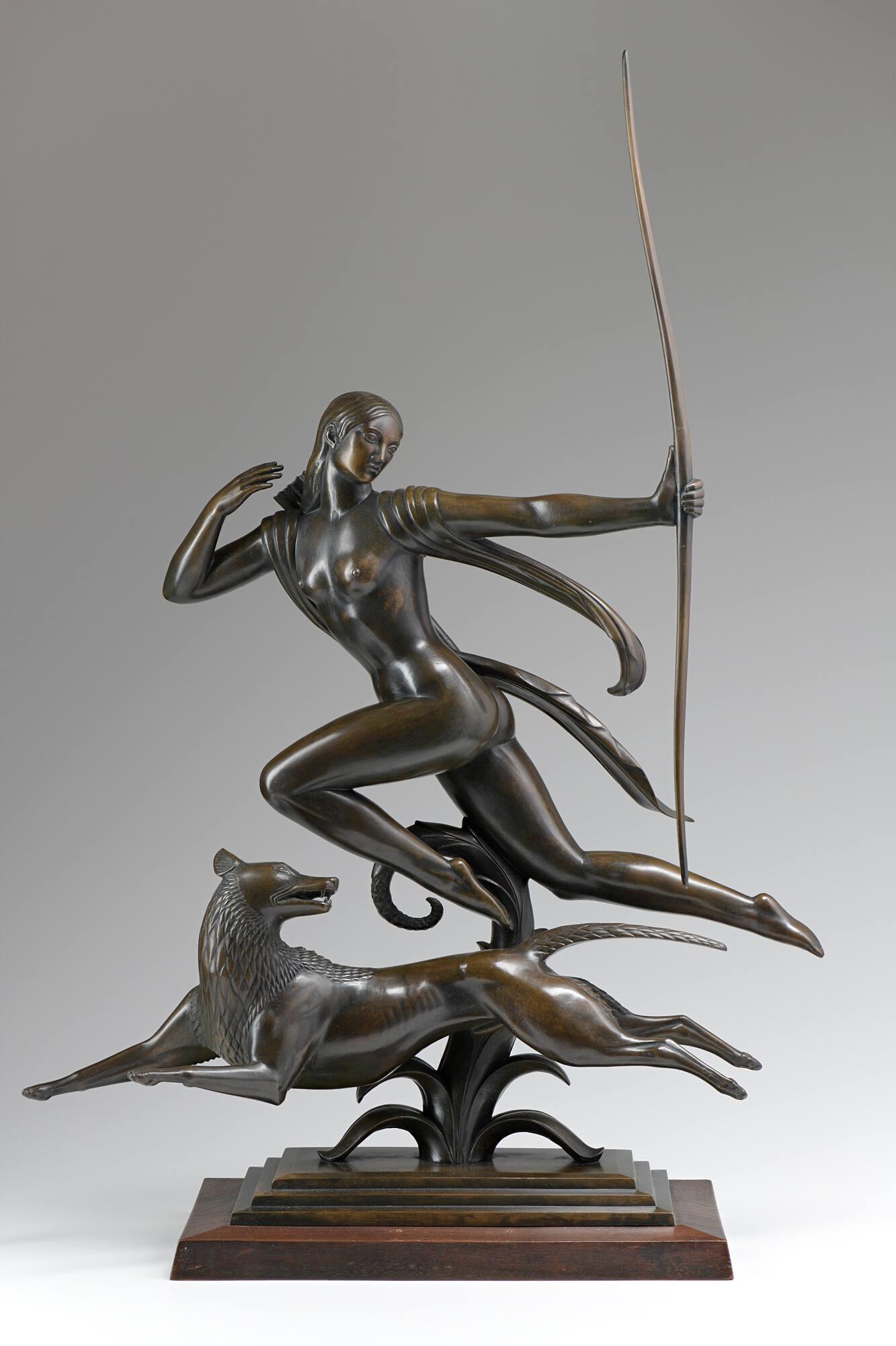 A bronze statue of Diana and a dog.