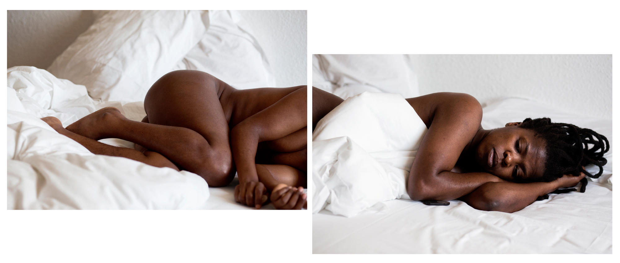 A person lays in a bed with white sheets curled up. 