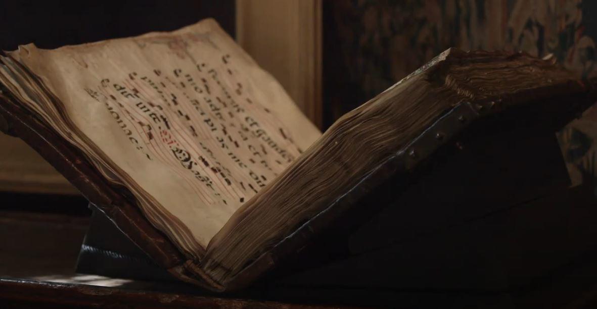 An old book opened up to a page. 