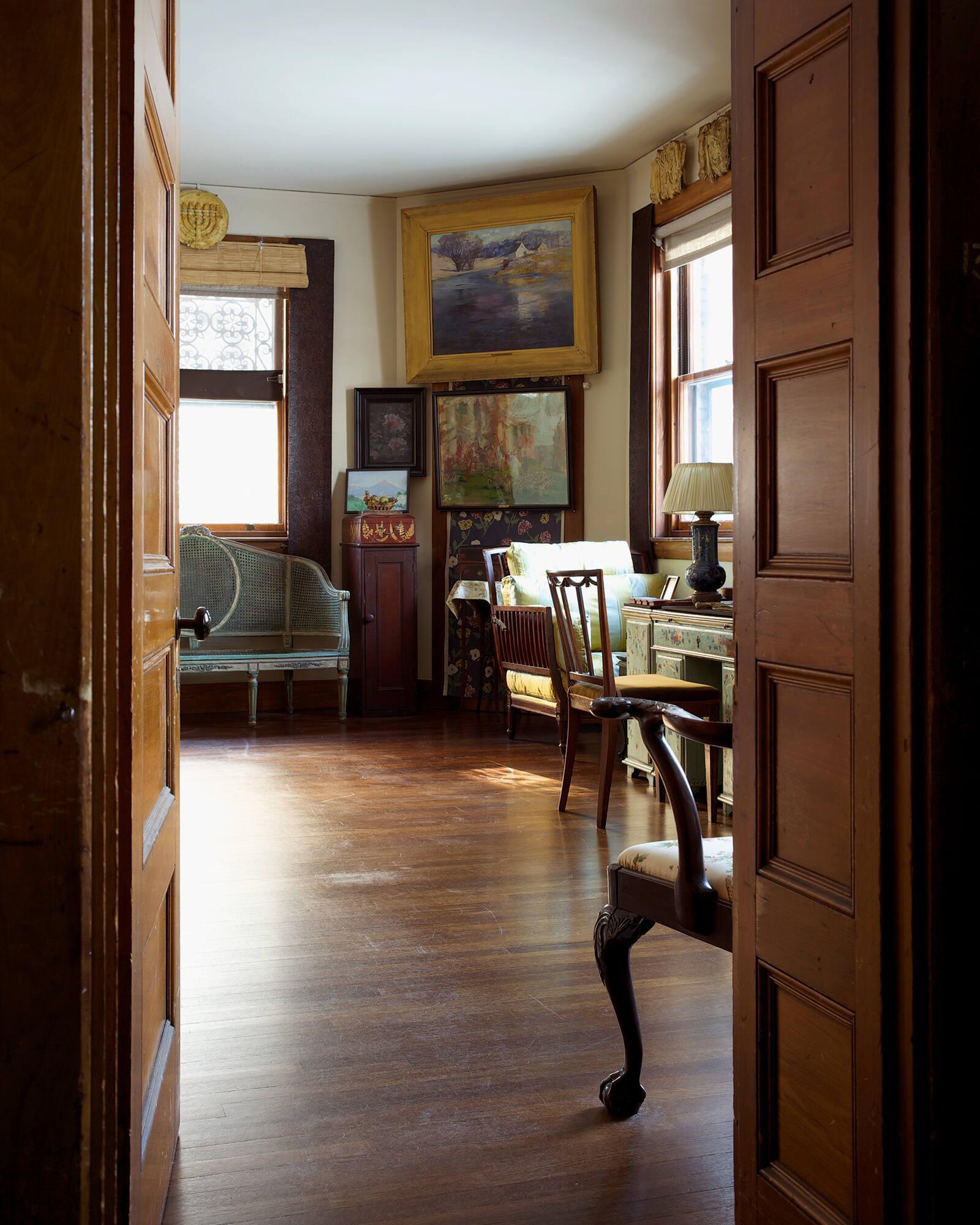 A view from a doorway into a room where The River at Concord painting lives.