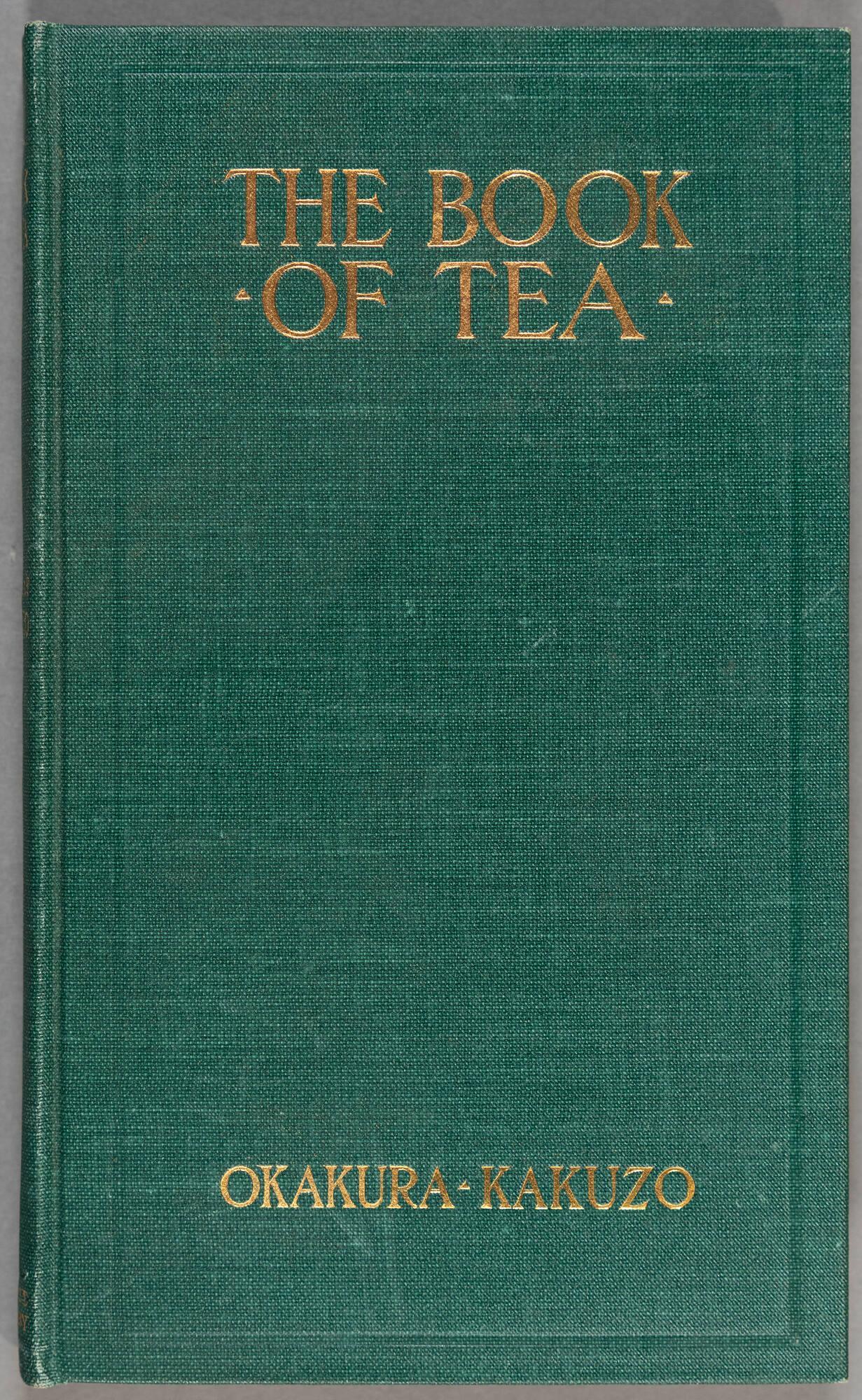 Green fabric book cover with the words The Book of Tea and Okakura-Kakuzo embossed in gold.