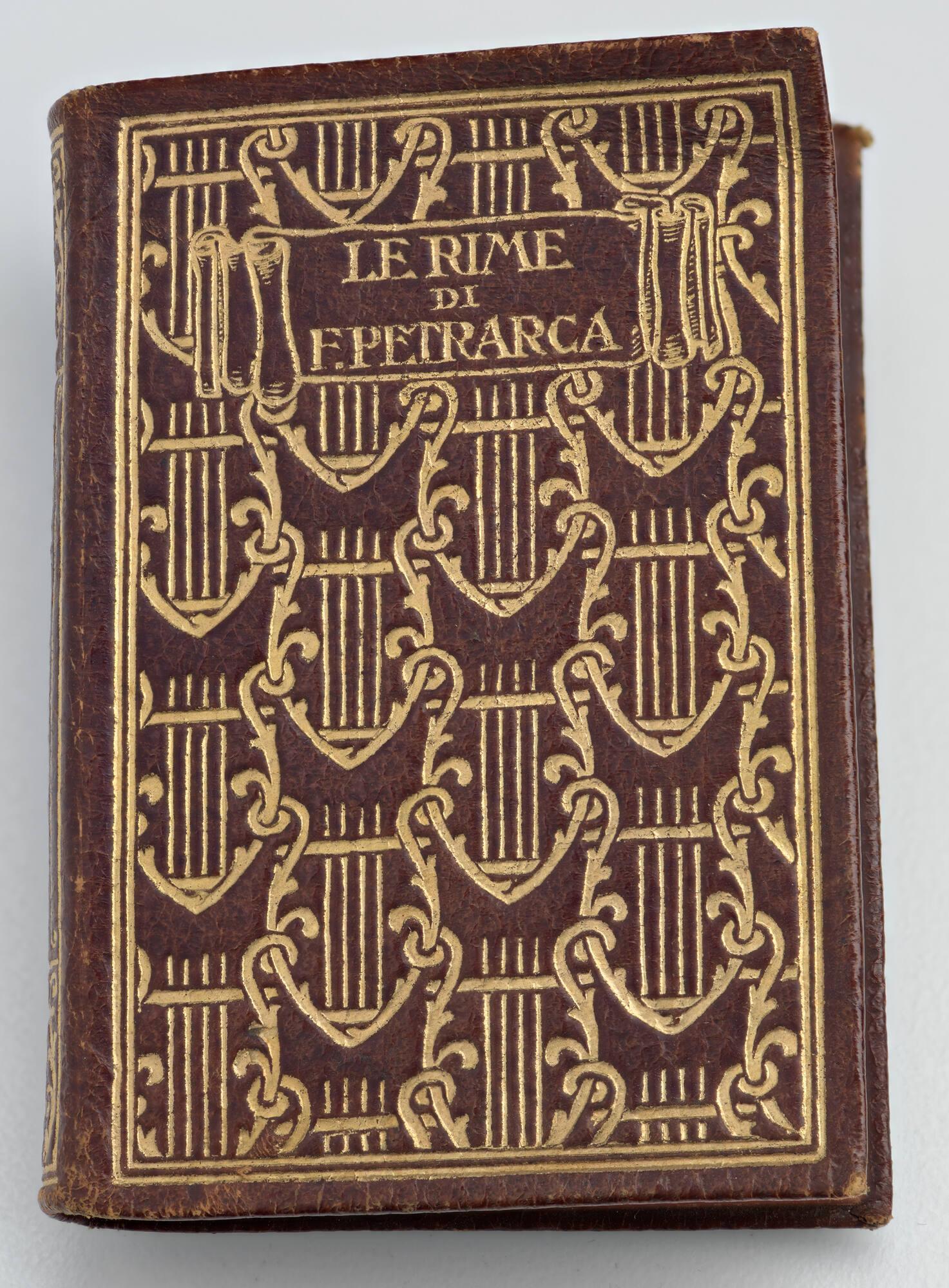 Small red leather book with gilded design and the title Le Rime de F. Petrarca.
