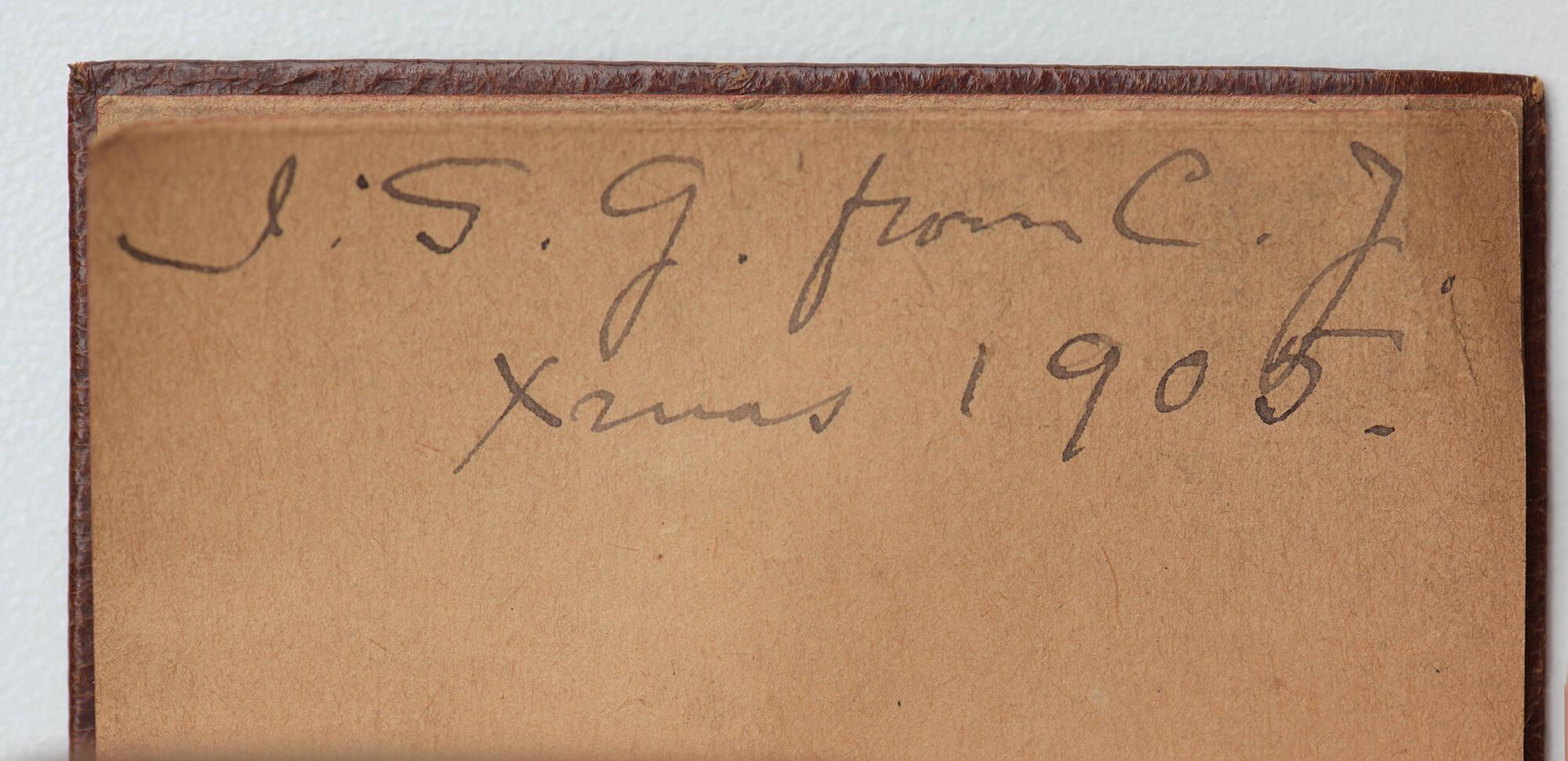 Open view of a small book showing a handwritten inscription on the title page, I.S.G. from C.J. [Clayton Johns] Xmas 1905