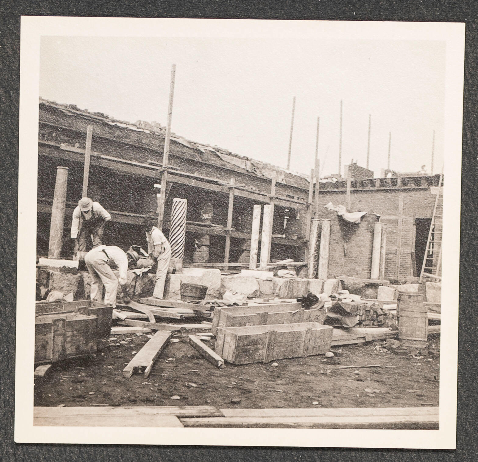 Black and white photographic print showing laborers working at the Fenway Court construction site.