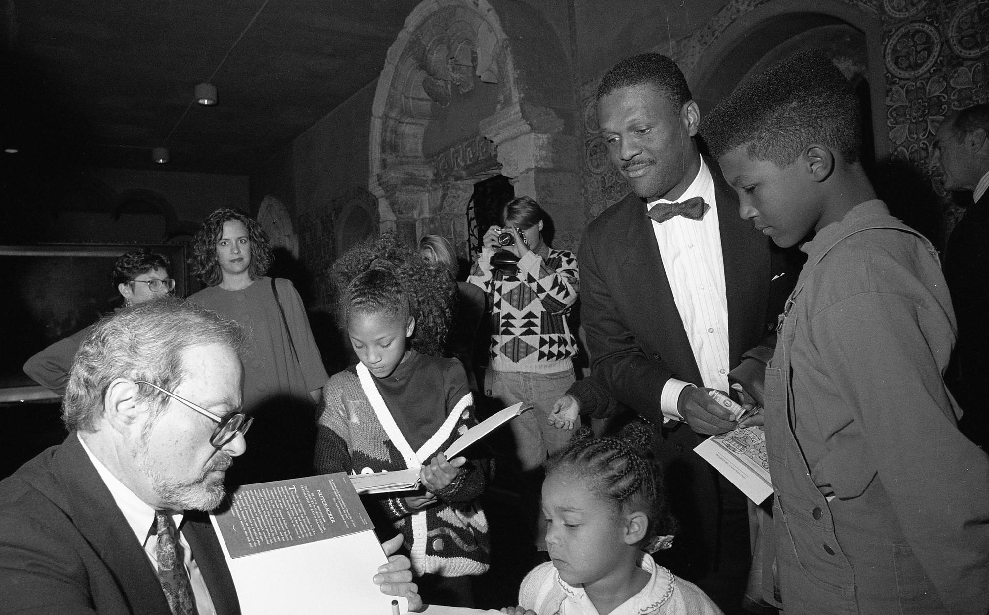 Maurice Sendak signs copies of his books for eager fans.