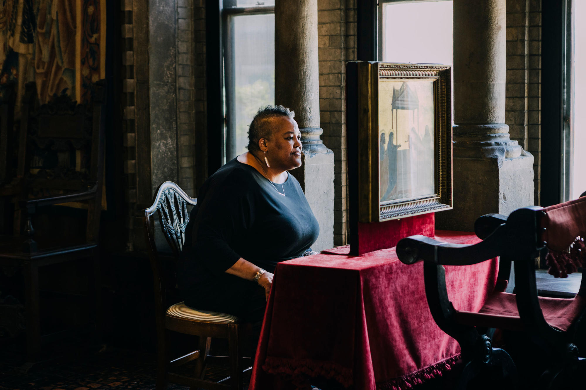 Photo of woman sitting at a table. 