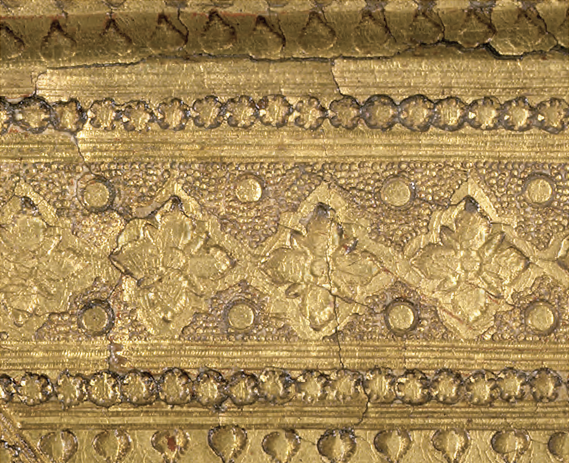 the use of an adhesive (mordant) to which gold power is applied to create fine details