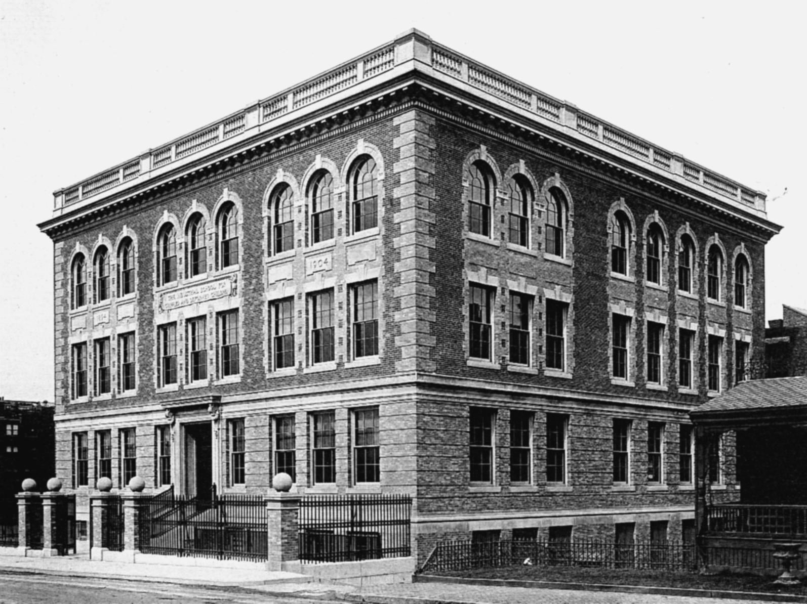 Three story Italianate stone and brick building on St. Botolph Street, home of Cotting School. 