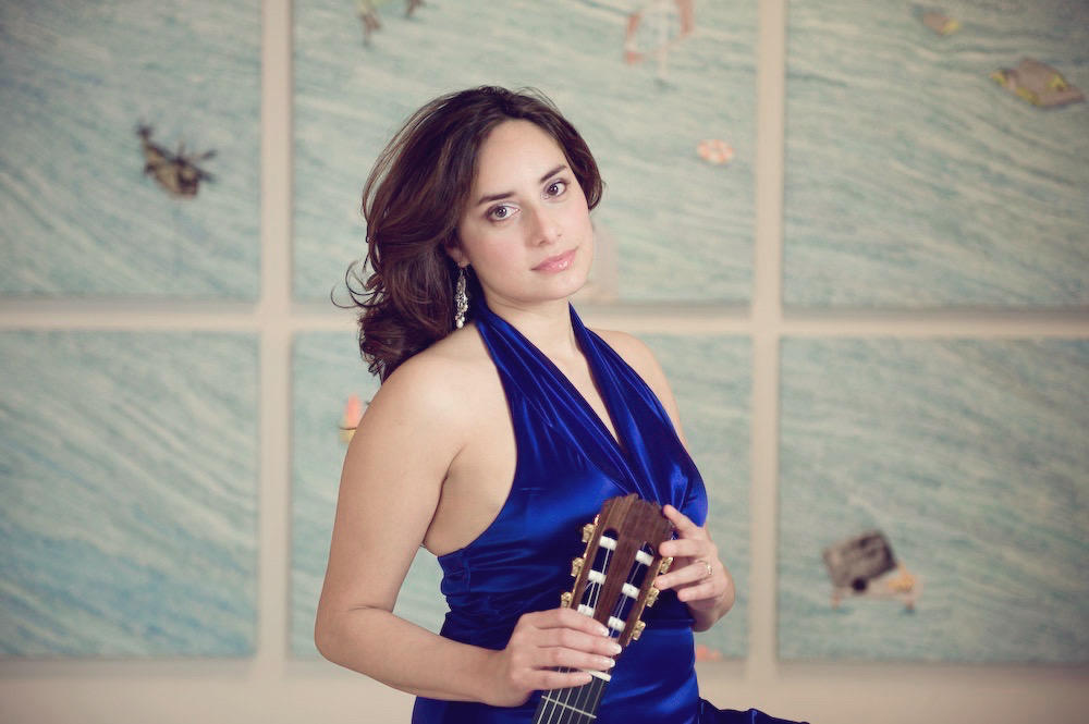 Photo of a woman with a guitar. 