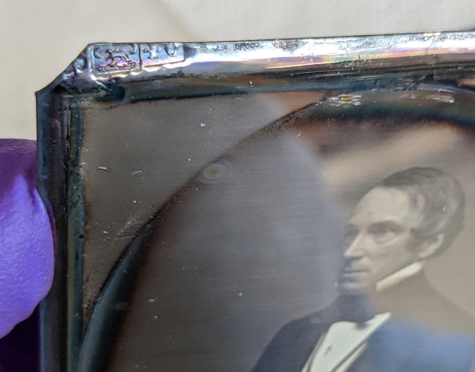 The top left corner of the daguerreotype plate for John L. Gardner, Sr. with the partial hallmark visible.