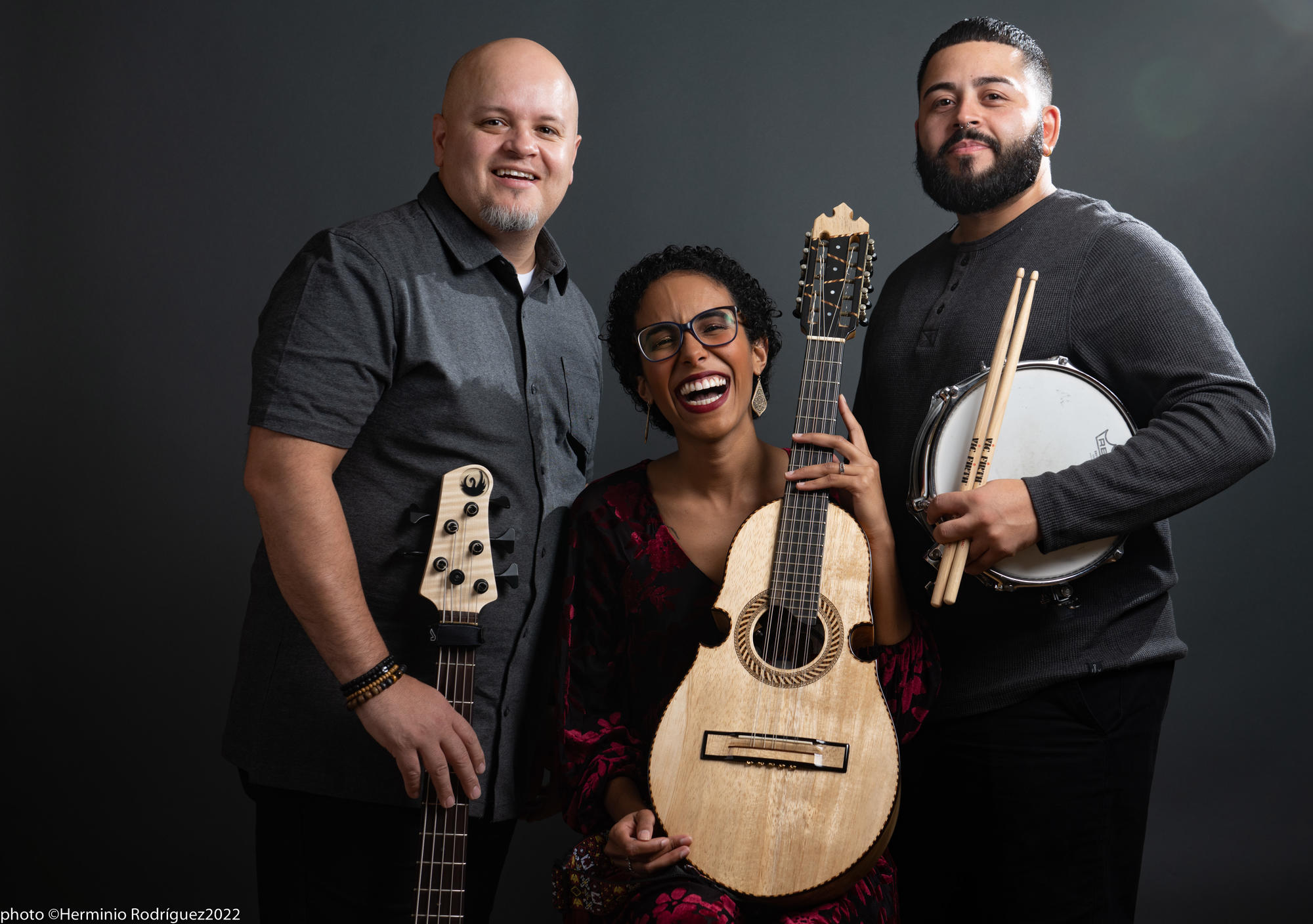 Photo of 3 people with instruments.
