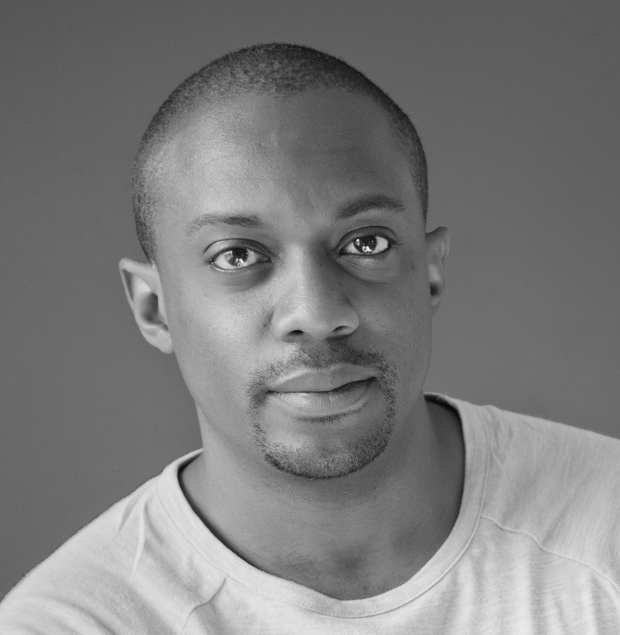 Black and white photo of a person in a white T-shirt. 