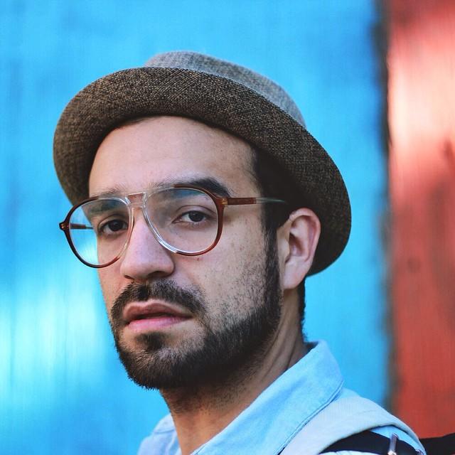 Photo of a person with glasses and a hat on.
