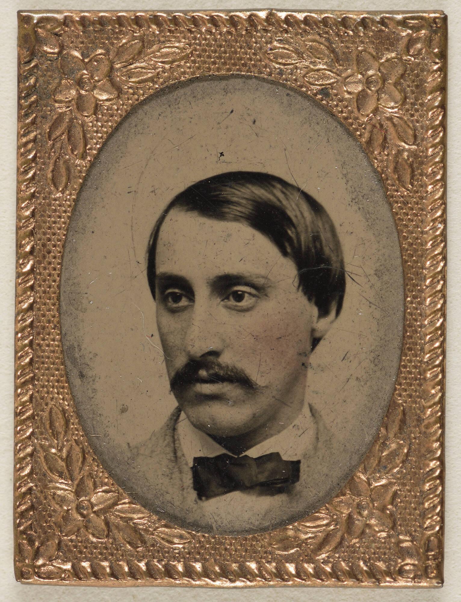 Black and white oval photograph of the head and shoulders of John Lowell Gardner Jr., a white man with short dark hair and mustache in 19th century dress.