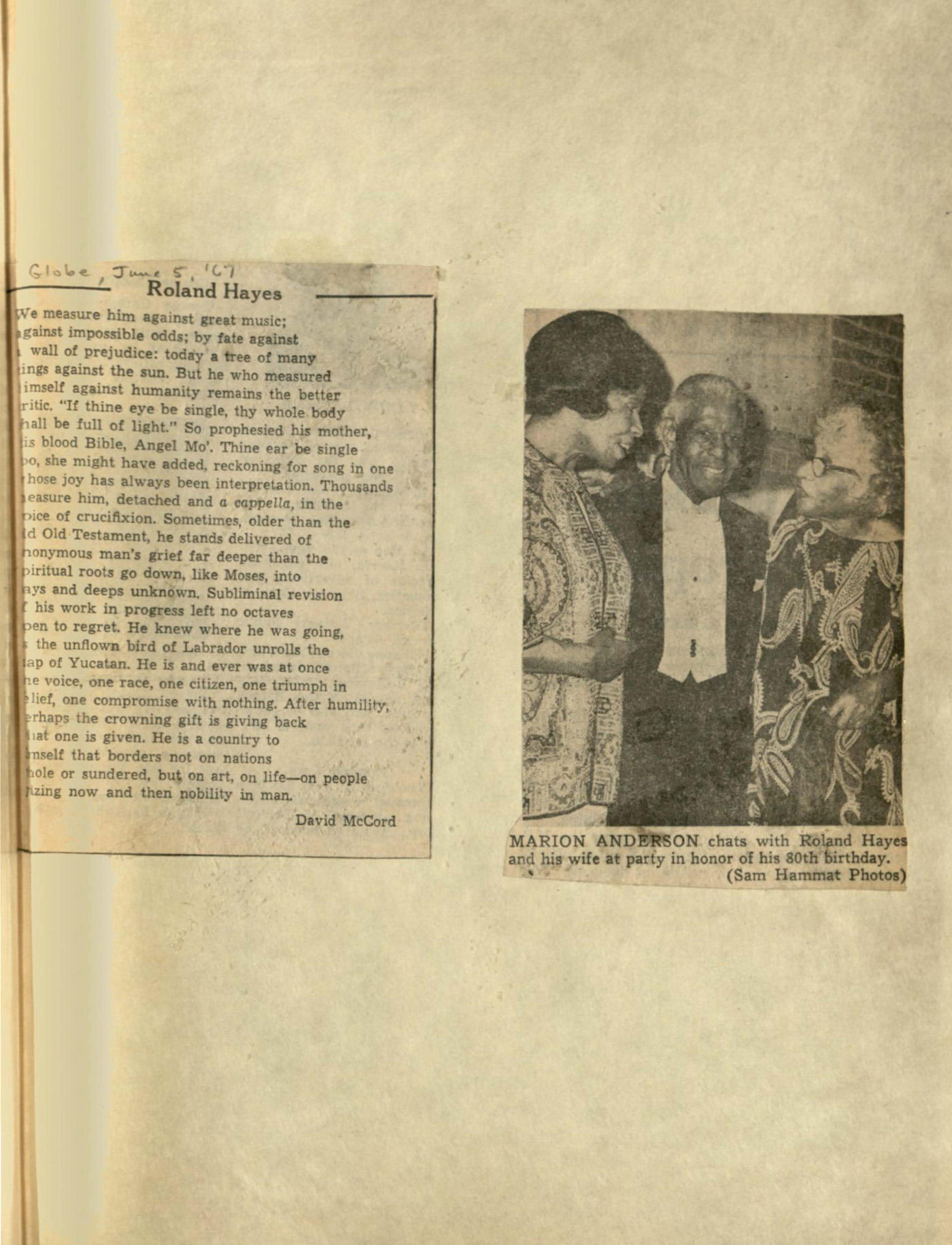 Roland Hayes, flanked by his wife Helen and Marian Anderson talking in front of a brick wall.  Roland Hayes looks directly at the camera while the women are in conversation. Clipping is pasted on a larger page.