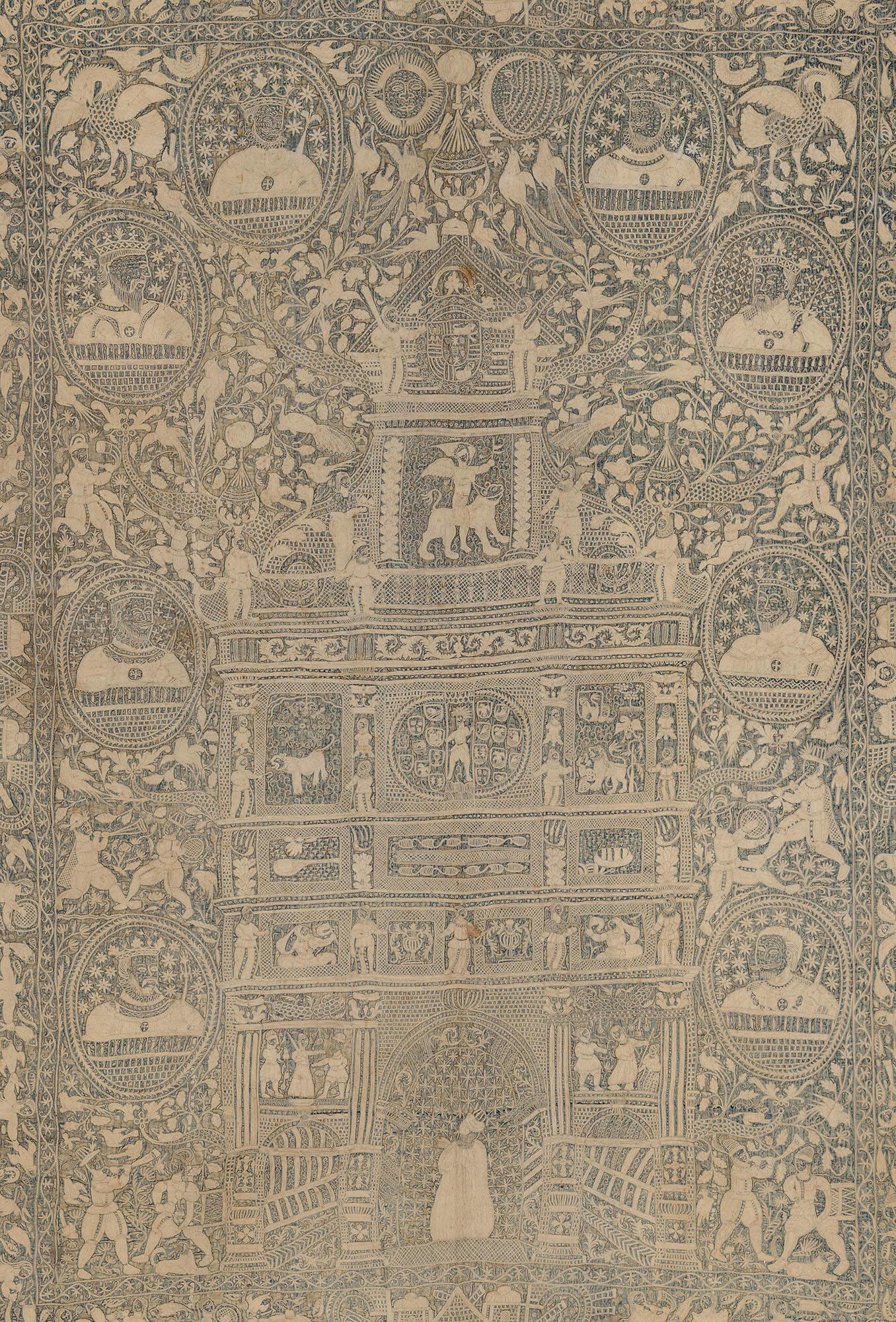 A detail of an embroidered wall hanging in the Gardner Museum of cream colored thread on a dark blue background. An arch with three openings has decorative features including human figures and animals.