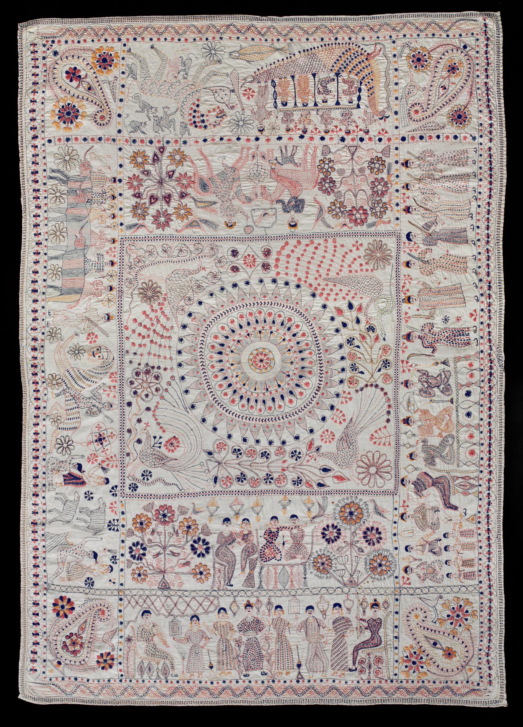 A white Kantha quilt embroidered with multicolored threads. A central field with a geometric and floral design with peacocks is surrounded by a border with people, animals, and plants.