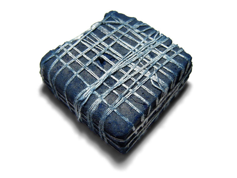 A square block of indigo blue dye.