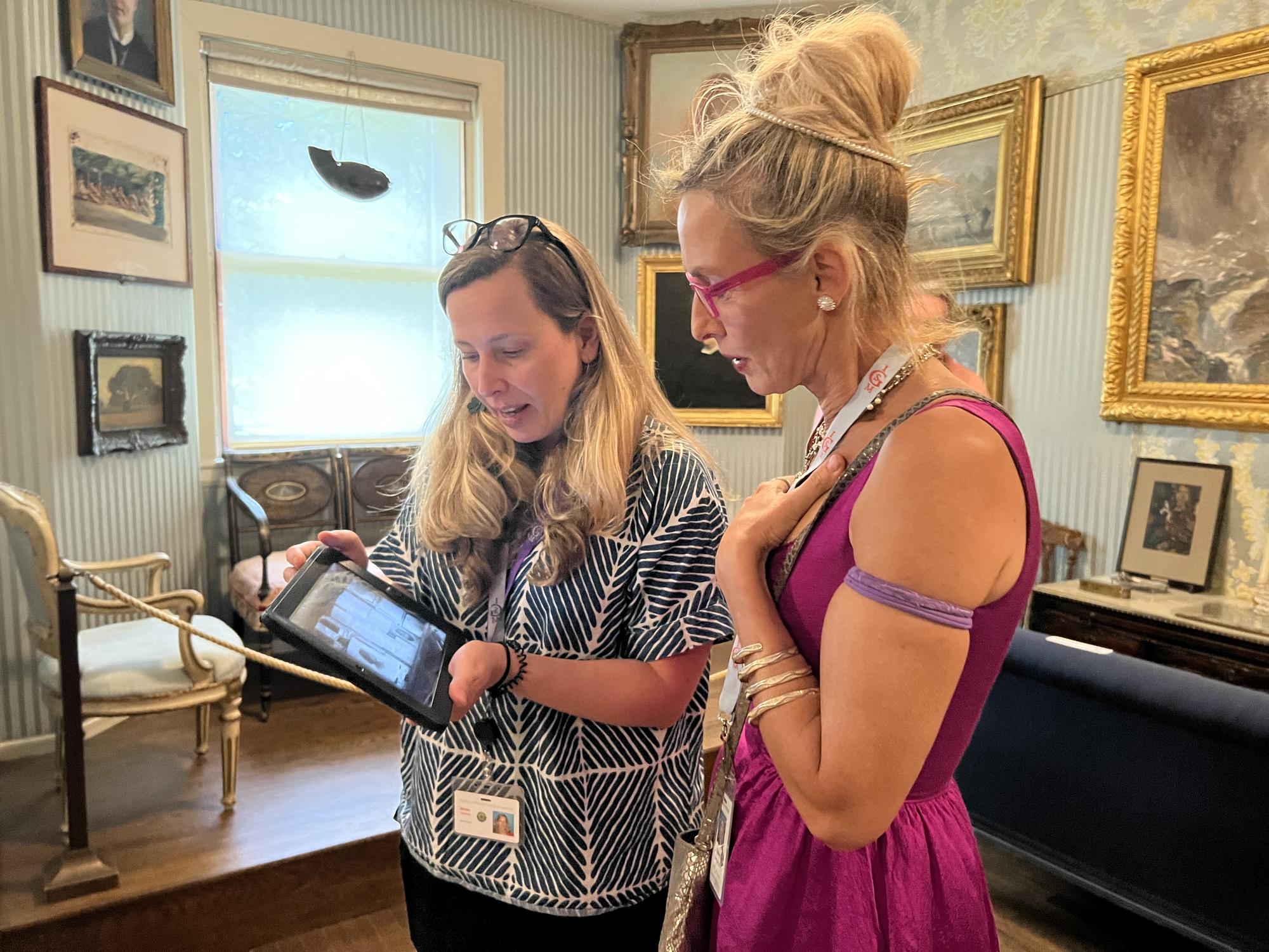 Natalie Jeremijenko and archivist Shana McKenna studying photographs of Isabella Gardner’s original ’Berenson case’ installation in the Blue Room 2022.
