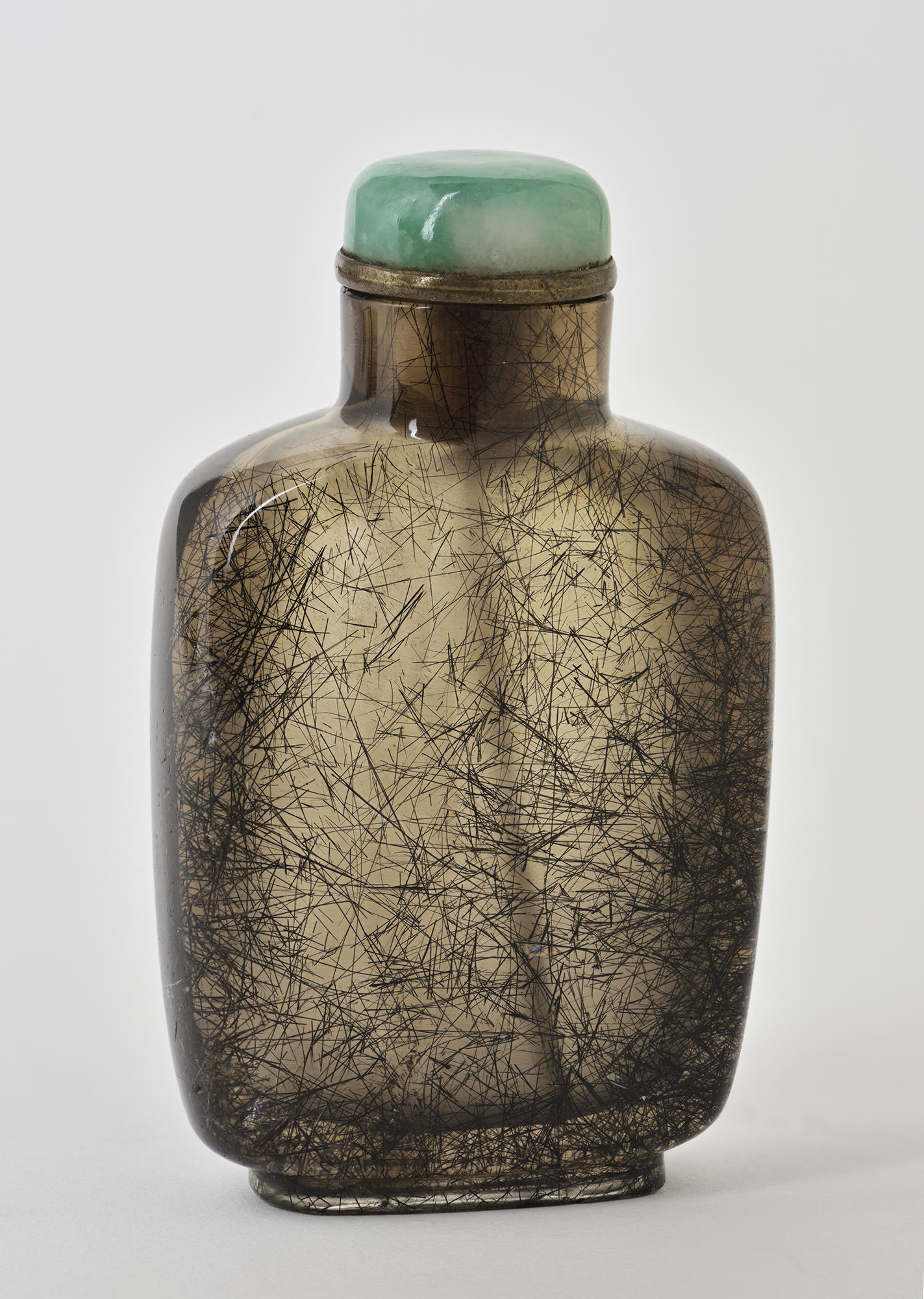 A rectangular snuff bottle with rounded corners with a green stopper. The body of the bottle is brown with black hairline fracture patterns. 