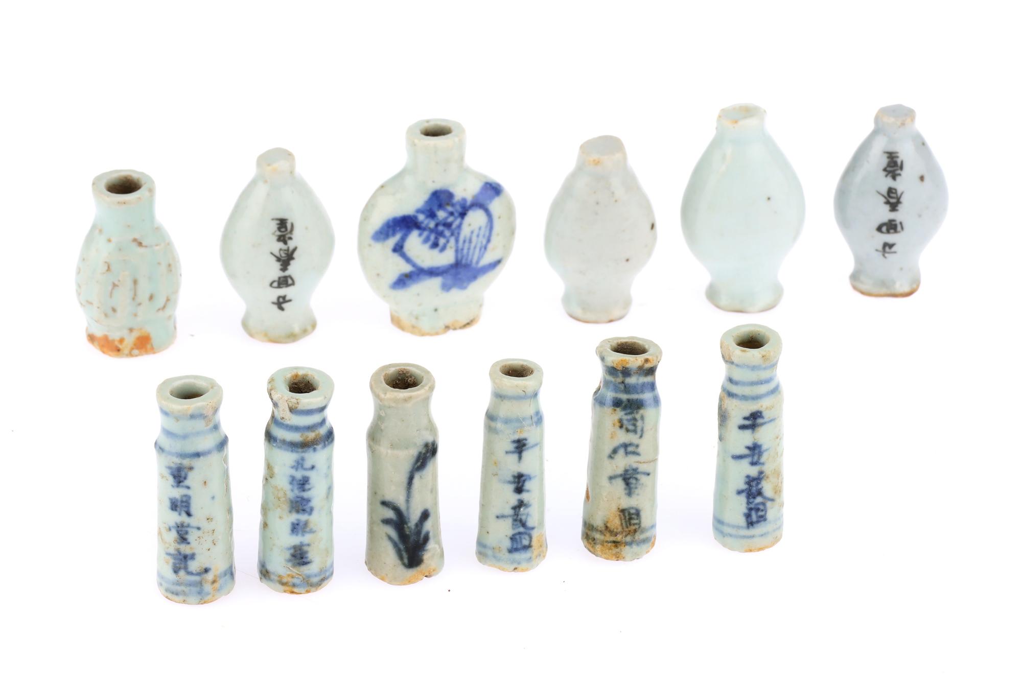 12 white antique chinese single dose medicine bottles with ovoid or straight bodies. Chinese characters are written on some bottles with blue underglaze and 2 bottles depict birds and plants. 
