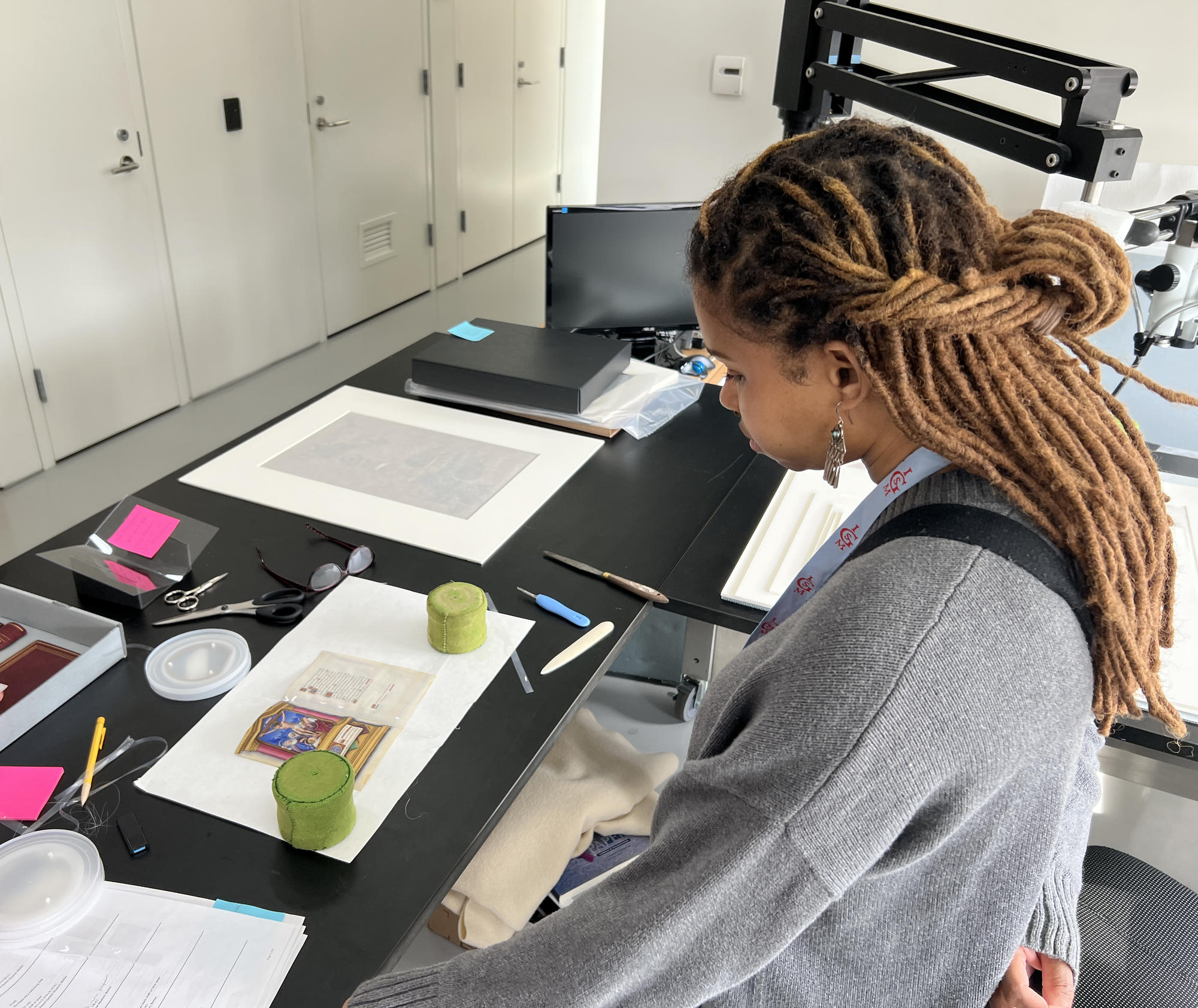 Fabiola Jean-Louis a painted and gilded book of hours by Jean Bourdichon in the Conservation lab, 2022.