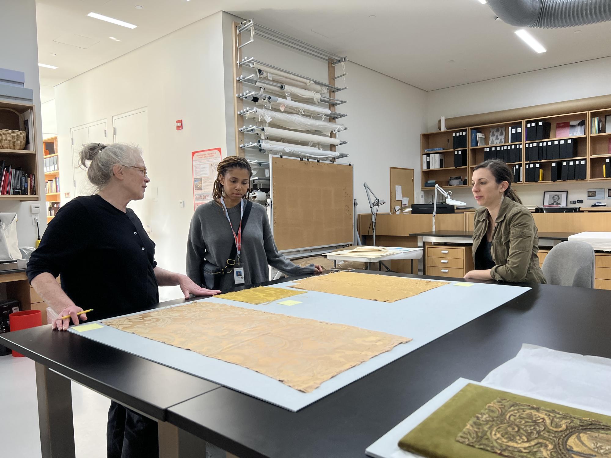 Examining pieces of the original wall fabric from the Dutch Room with conservator Tess Fredette, 2022.