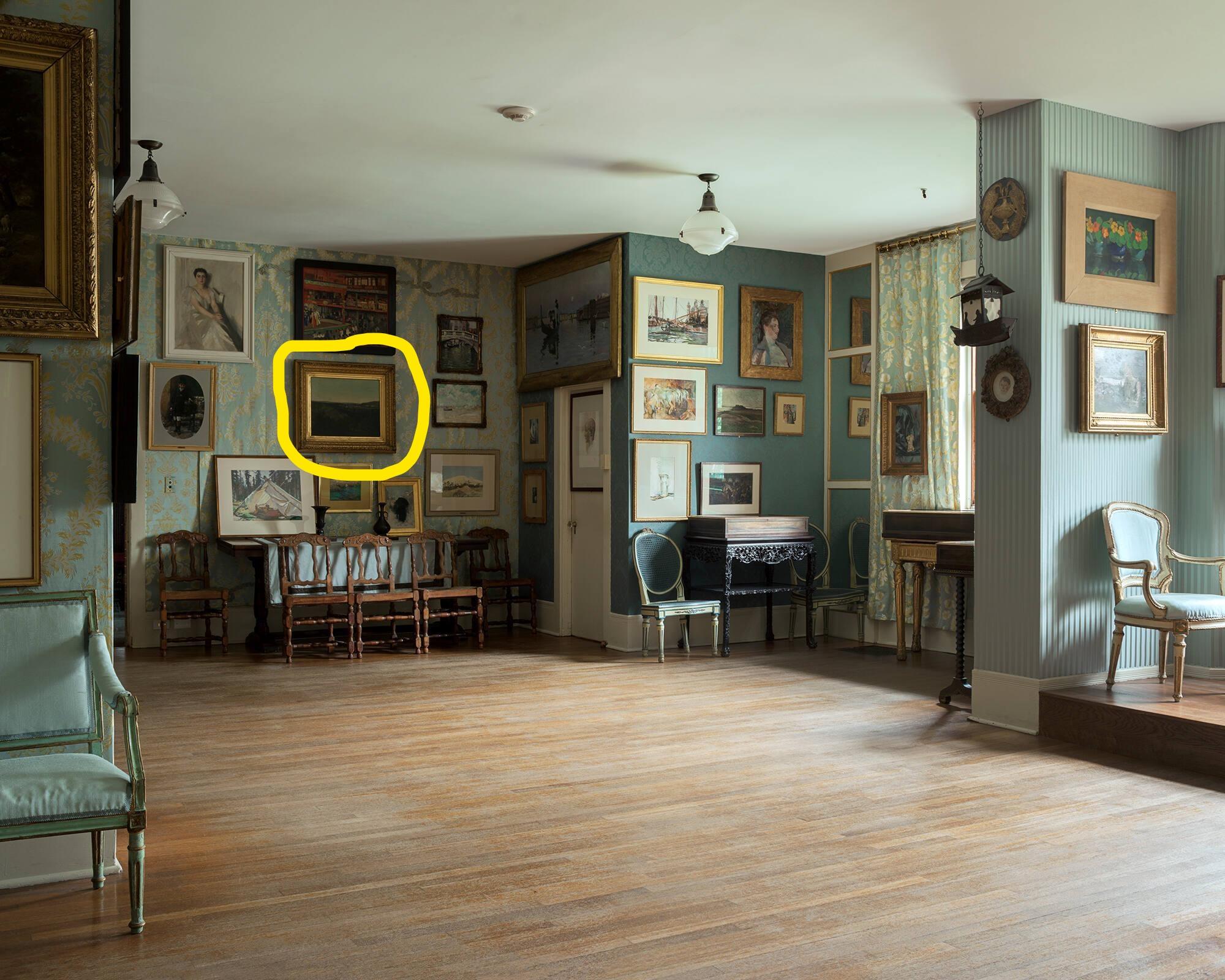A photograph of the Gardner Museum’s Blue Room, one of the museum’s galleries, with hardwood floors, and several framed paintings hanging on blue walls with one of the paintings circled in yellow.