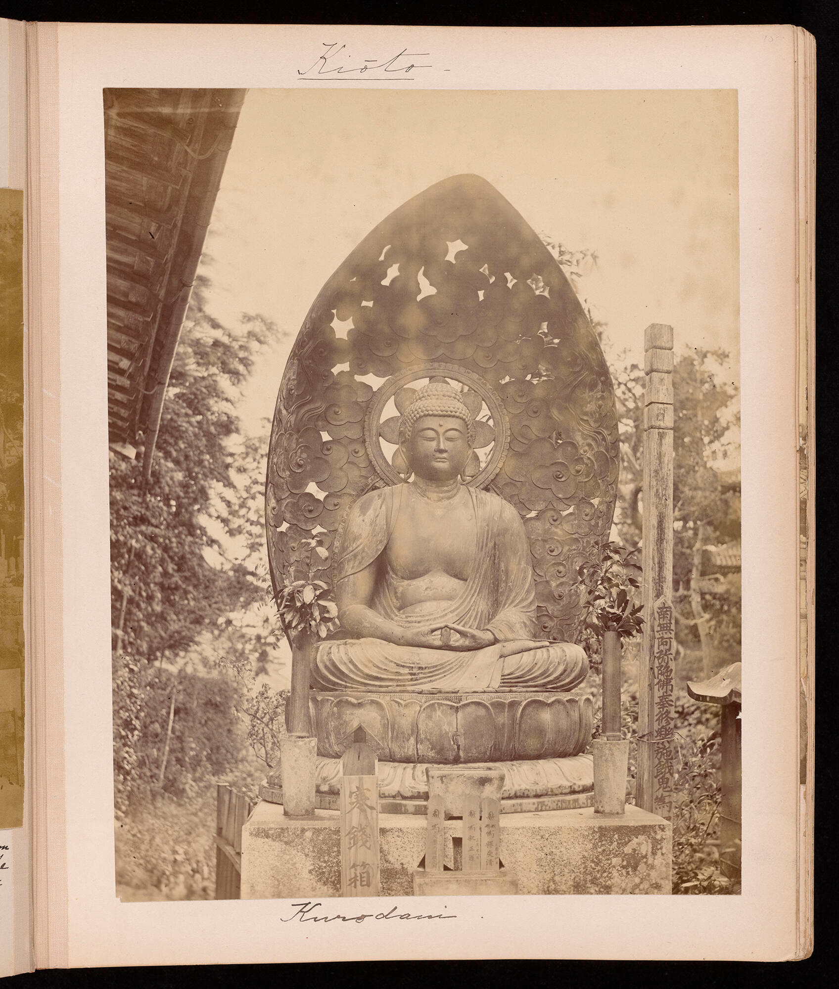 A page from Isabella Stewart Gardner’s travel album with a black and white photograph of a seated Buddha with a large shell behind.