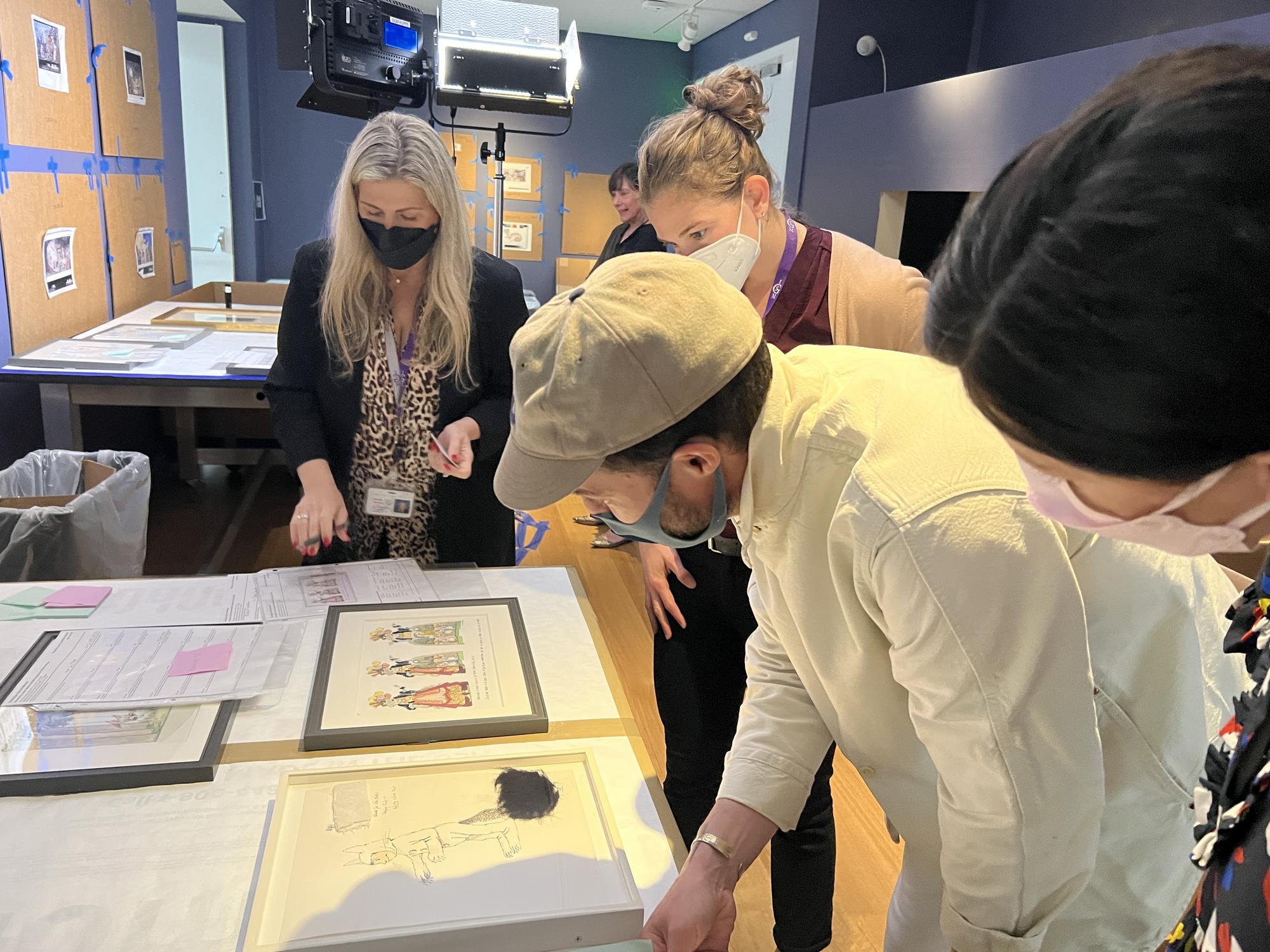 Oliver Jeffers examines drawings by Maruice Sendak as the Drawing the Curtain exhibition is installed, 2022